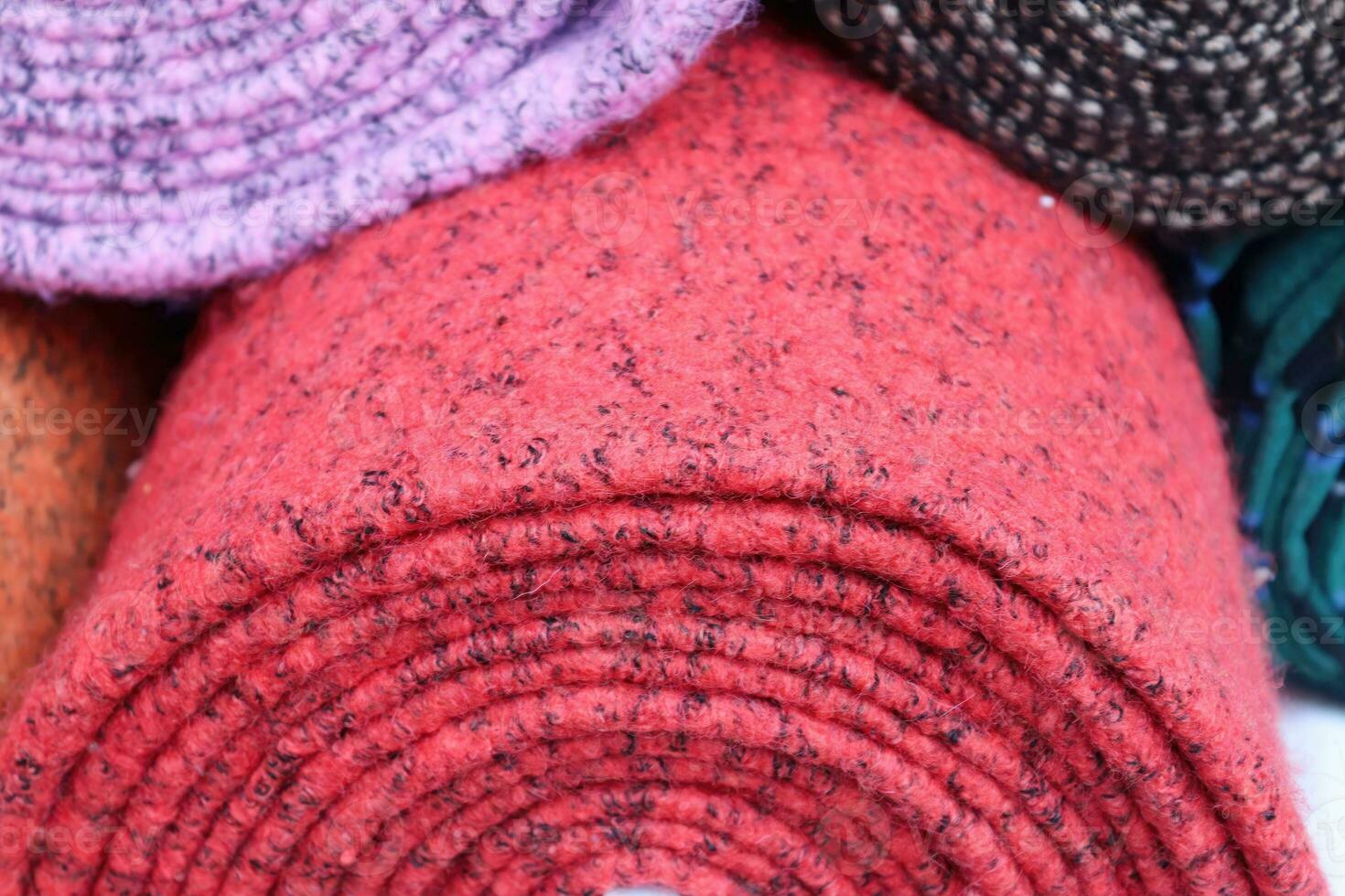 Detailed close up view on samples of cloth and fabrics in different colors found at a fabrics market photo