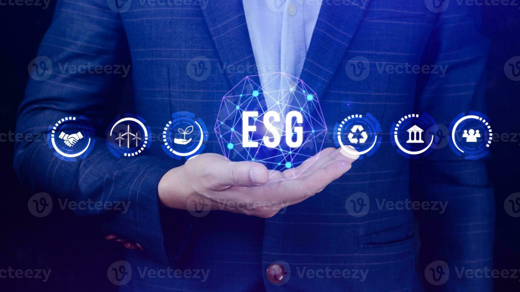 ESG icon concept in the hand for environmental, social and governance in sustainable and ethical business on the Network connection, businessman pressing button on screen. photo