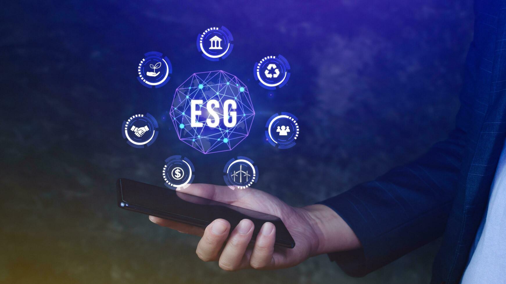 ESG icon concept use a smartphone to analyze ESG for environmental, social and governance in sustainable and ethical business on the Network connection, businessman pressing button on screen. photo