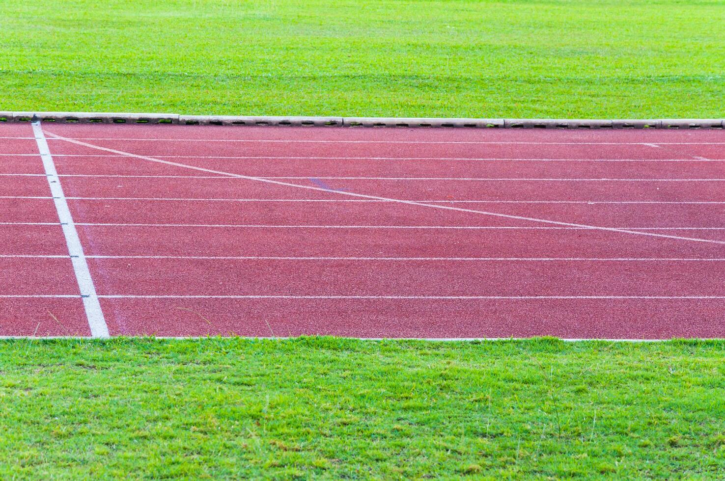 running track and green grass,Direct athletics Running track at Sport Stadium photo