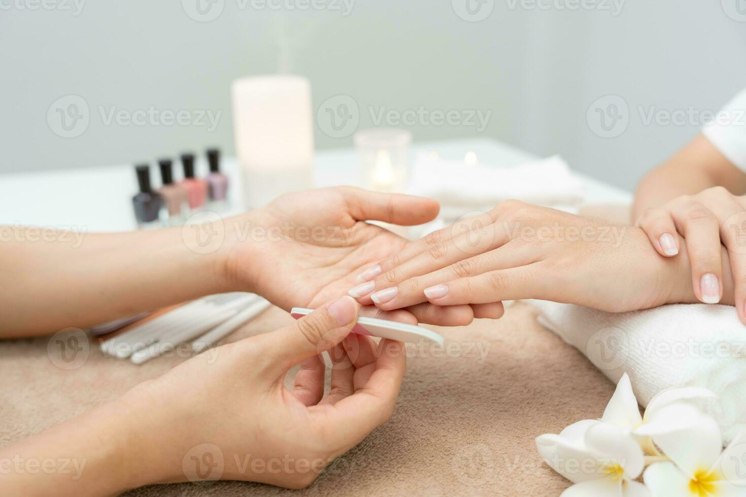 Woman receive care service by professional Beautician Manicure at spa centre. Nail beauty salon use nail file for Glazing treatment. manicurist make nail customer to beautiful. body care spa treatment photo