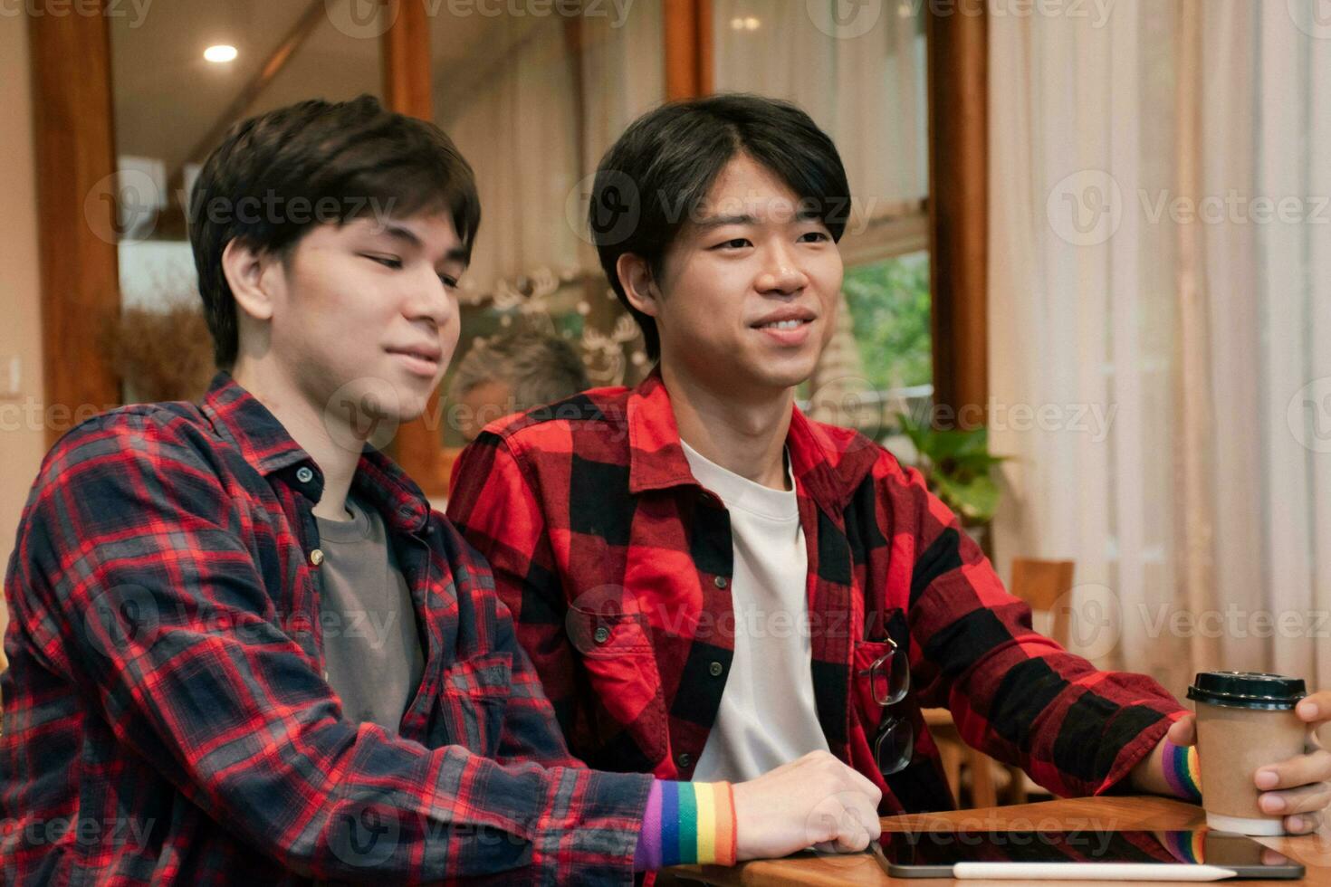 asian young adult couple spending their free times by talking and consulting their daily life problems in coffee shop, happy life, gender diversity and teenagers lifestyle concept. photo