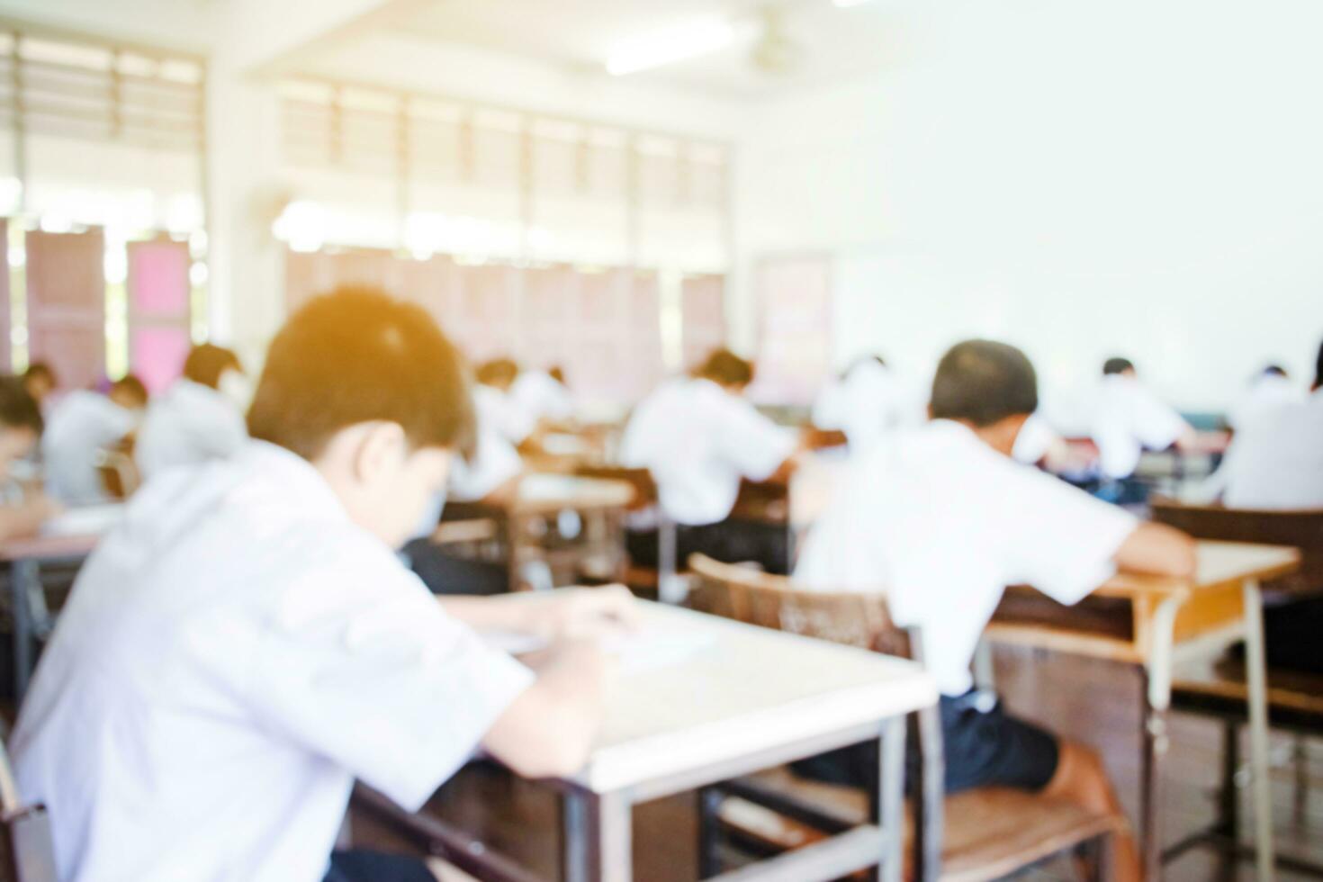 Blurred image of classroom during final test of secondary school in rural area of Thailand, concept for educational events background around the world. photo