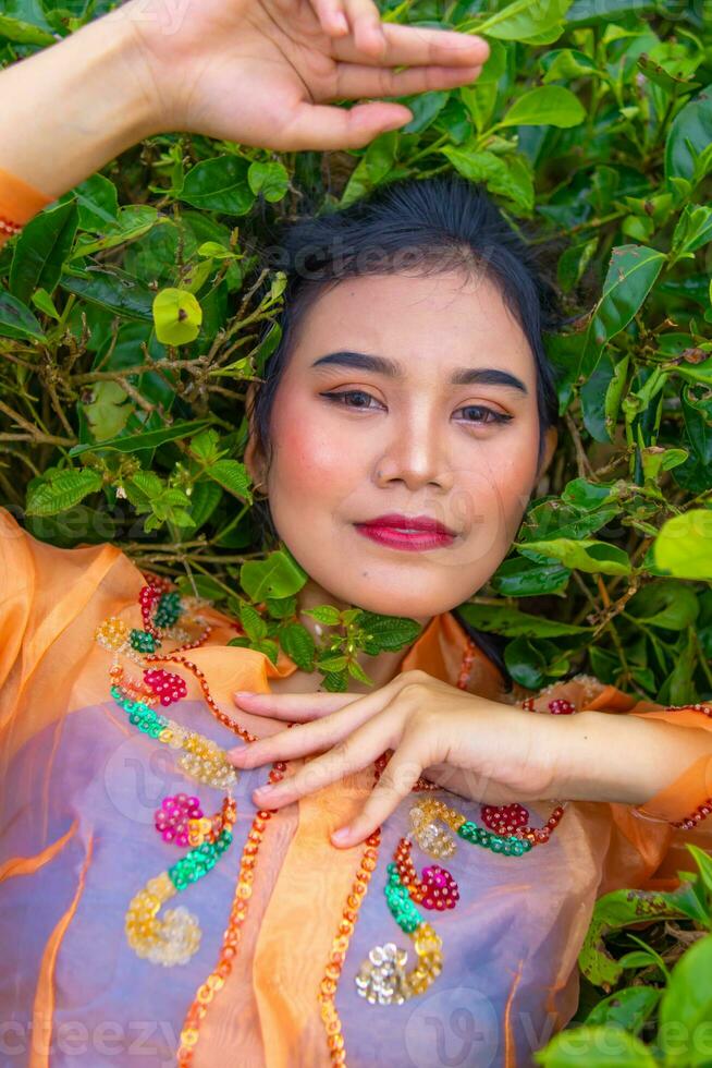 an Asian woman sleeping on green tea leaves photo