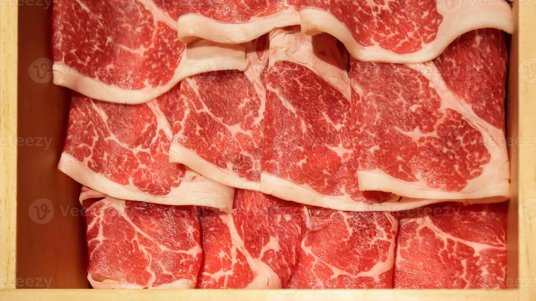 Fresh raw beef slices meat for Japanese food shabu shabu or yakiniku barbeque. Slice of high quality wagyu meat. photo