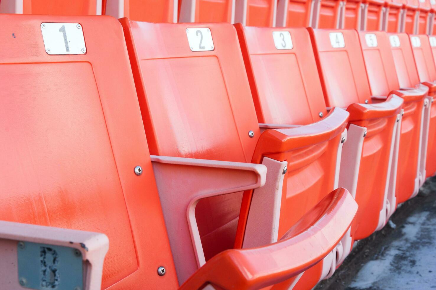 Empty orange seats at stadium,Rows of seat on a soccer stadium photo