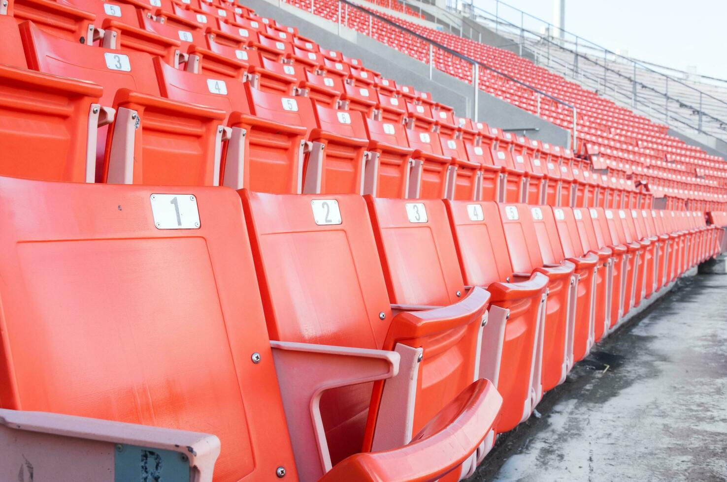 Empty orange seats at stadium,Rows of seat on a soccer stadium photo