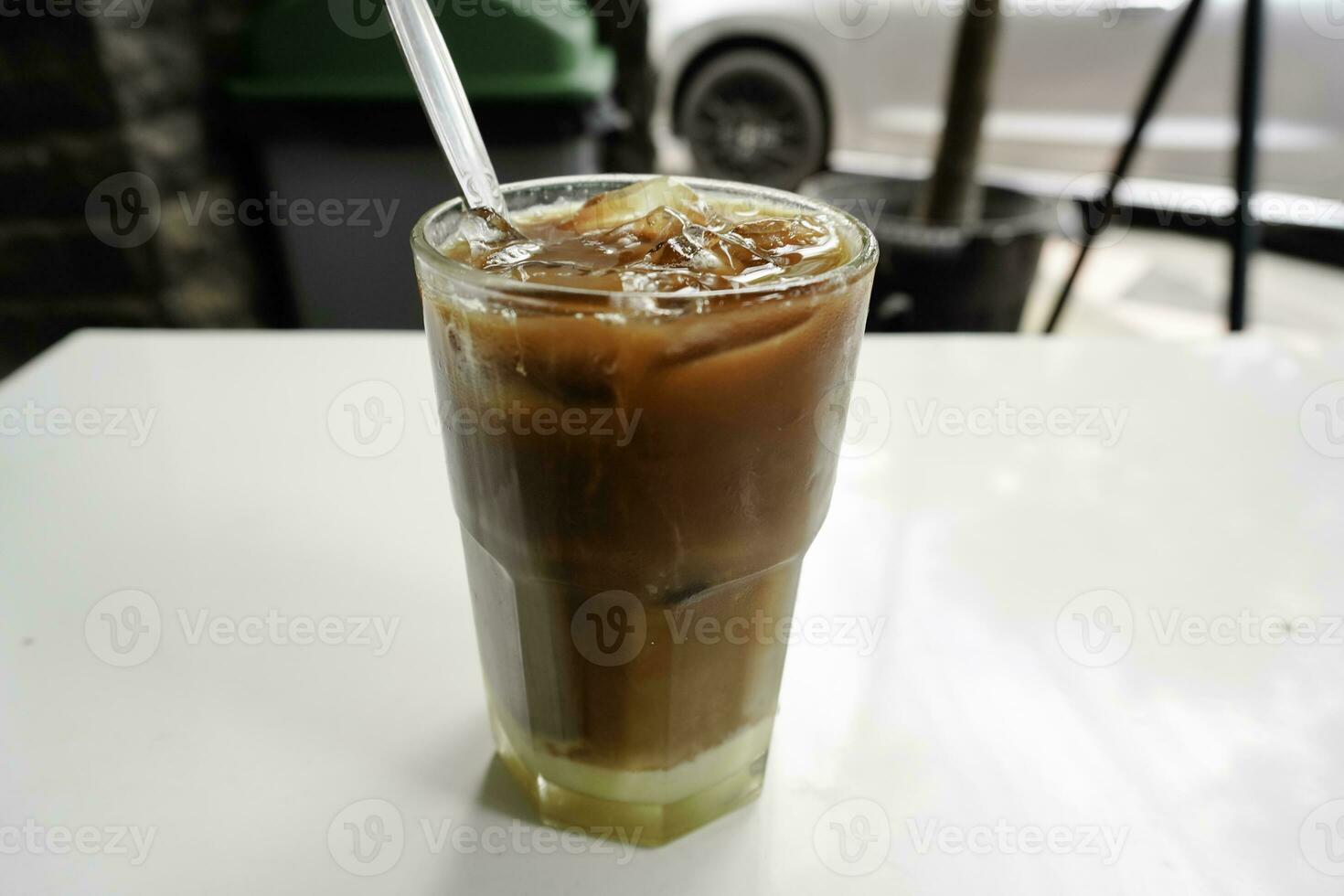 A glass of iced coffee milk kopitiam style, showing separate in a layer the bottom as milk top by coffee. photo