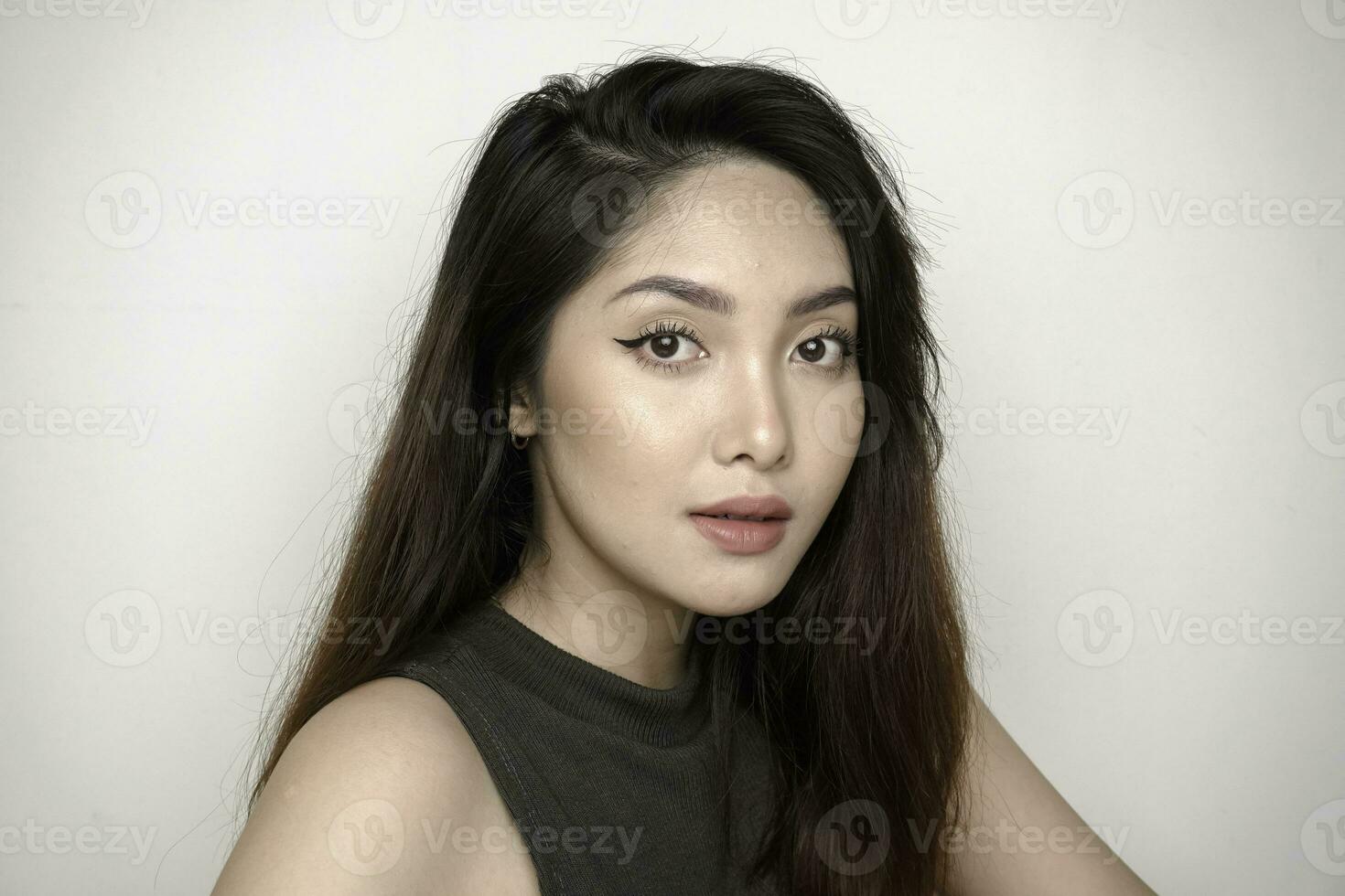Indonesian beautiful female wearing colorful eyeshadow on her eyes. Clean skin, fashion naturel make-up. photo