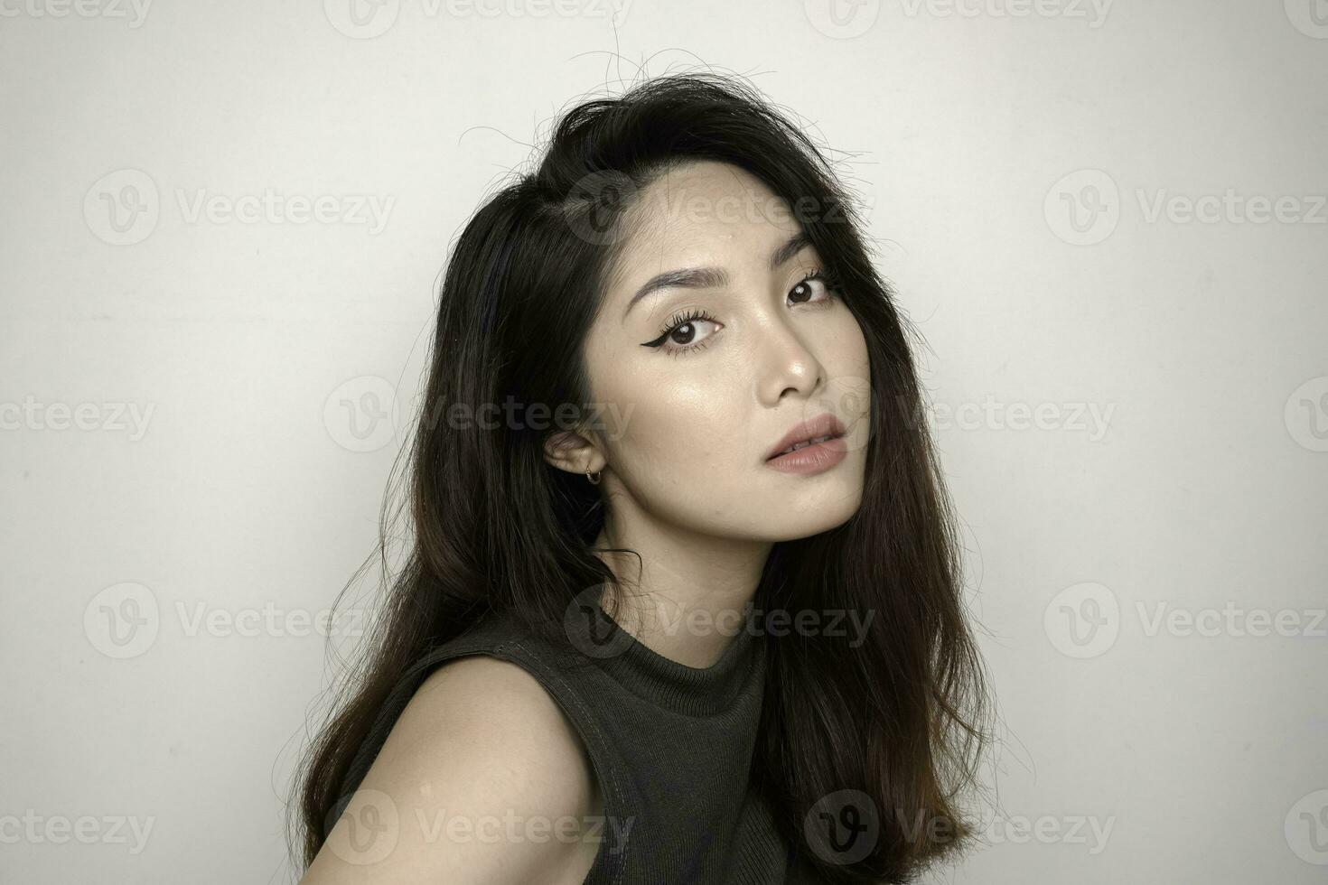 Indonesian beautiful female wearing colorful eyeshadow on her eyes. Clean skin, fashion naturel make-up. photo
