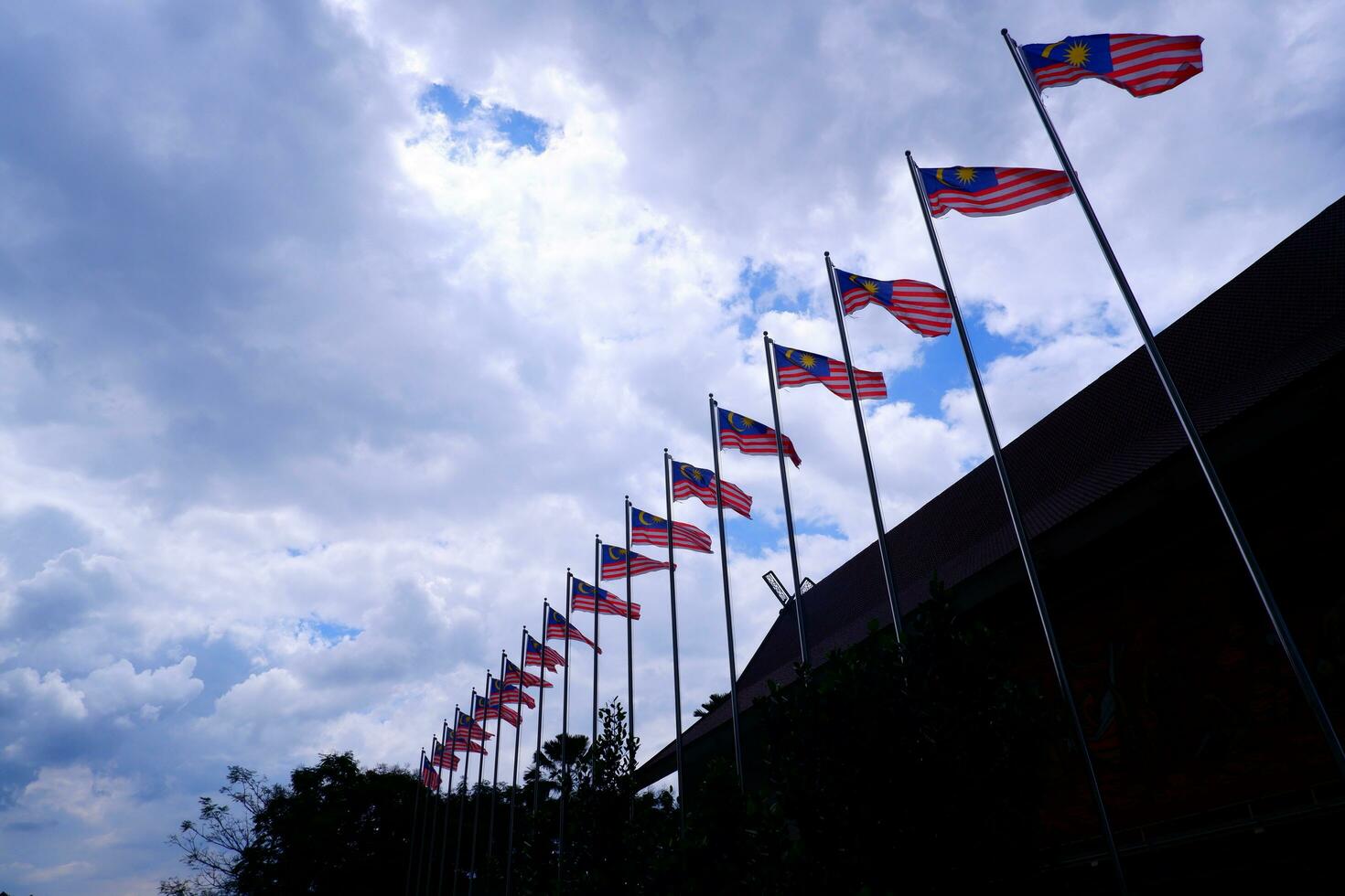 Kuala Lumpur, Malaysia, 2023 - sky and flags from low angle photo