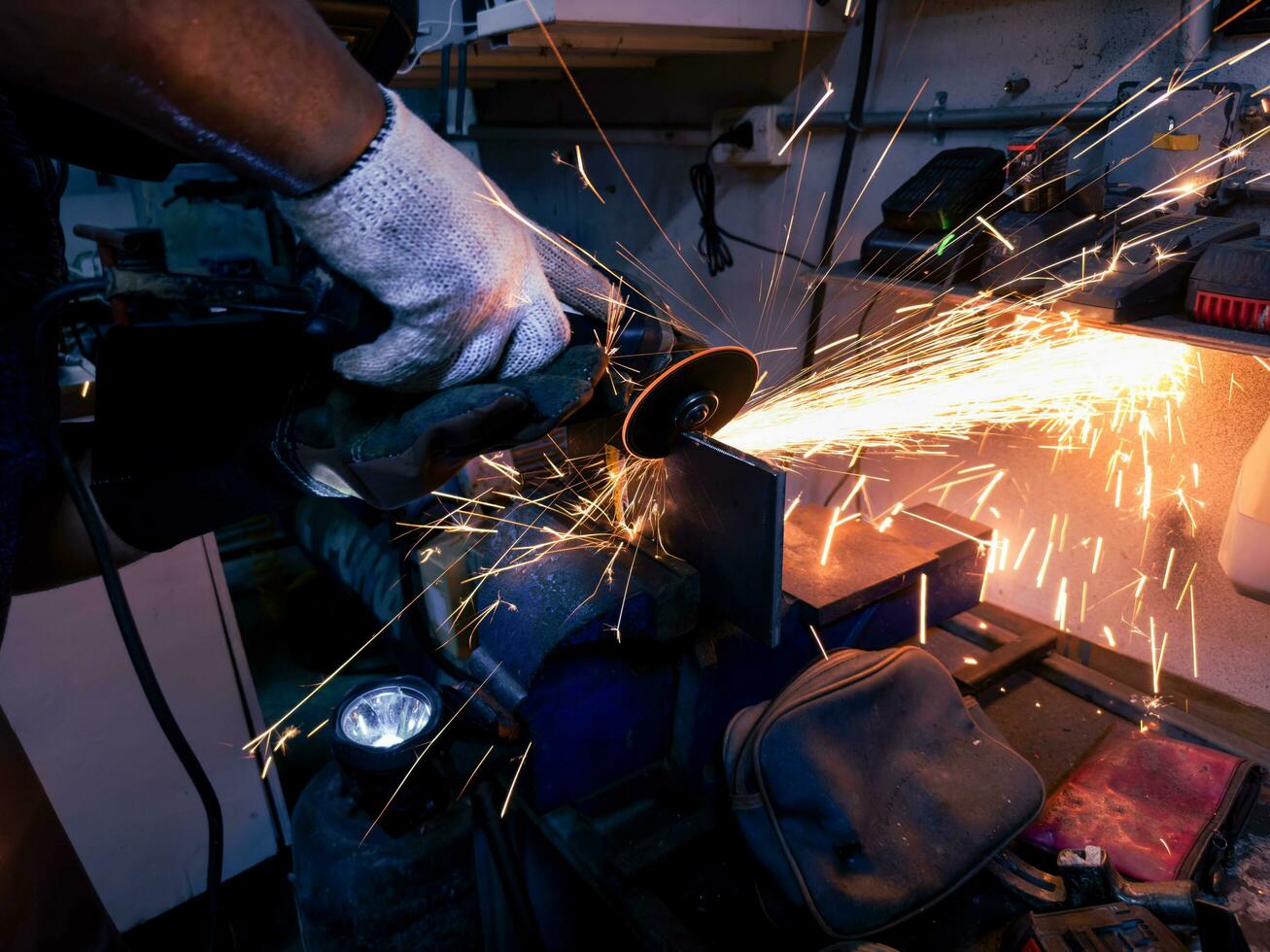 sparks from electric wheel grindig on steel structure in factory photo