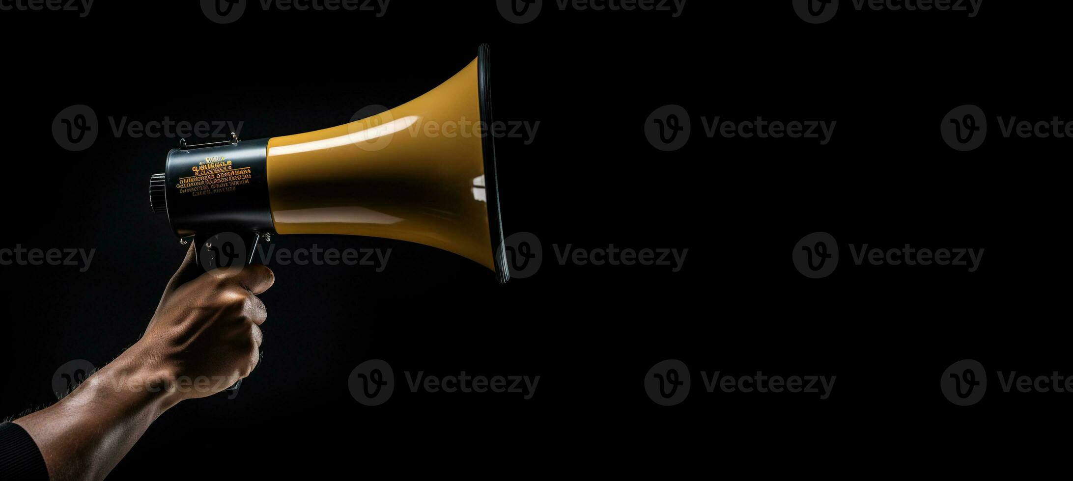 Generative AI, golden megaphone in hand on a empty black background, panoramic image with copy space photo