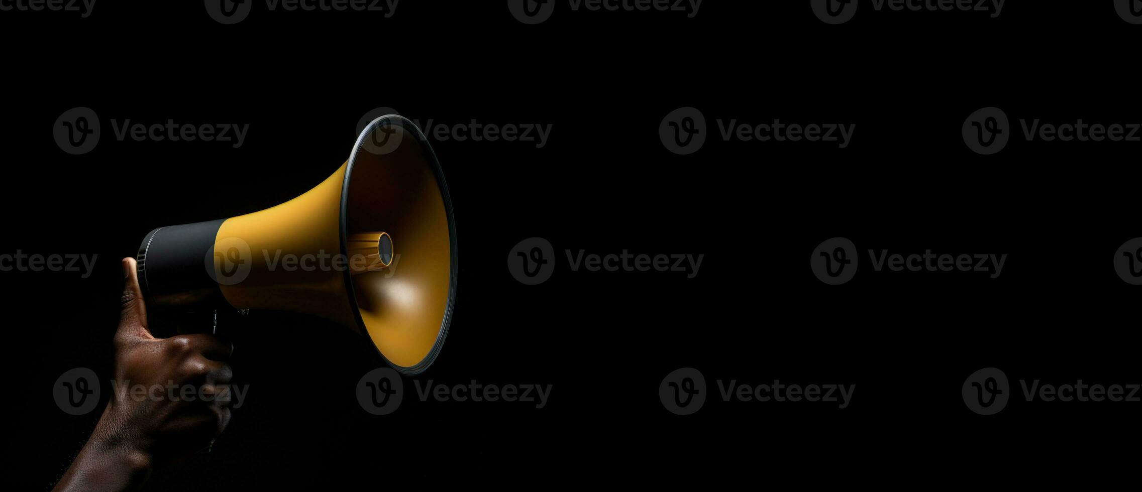 Generative AI, golden megaphone in hand on a empty black background, panoramic image with copy space photo