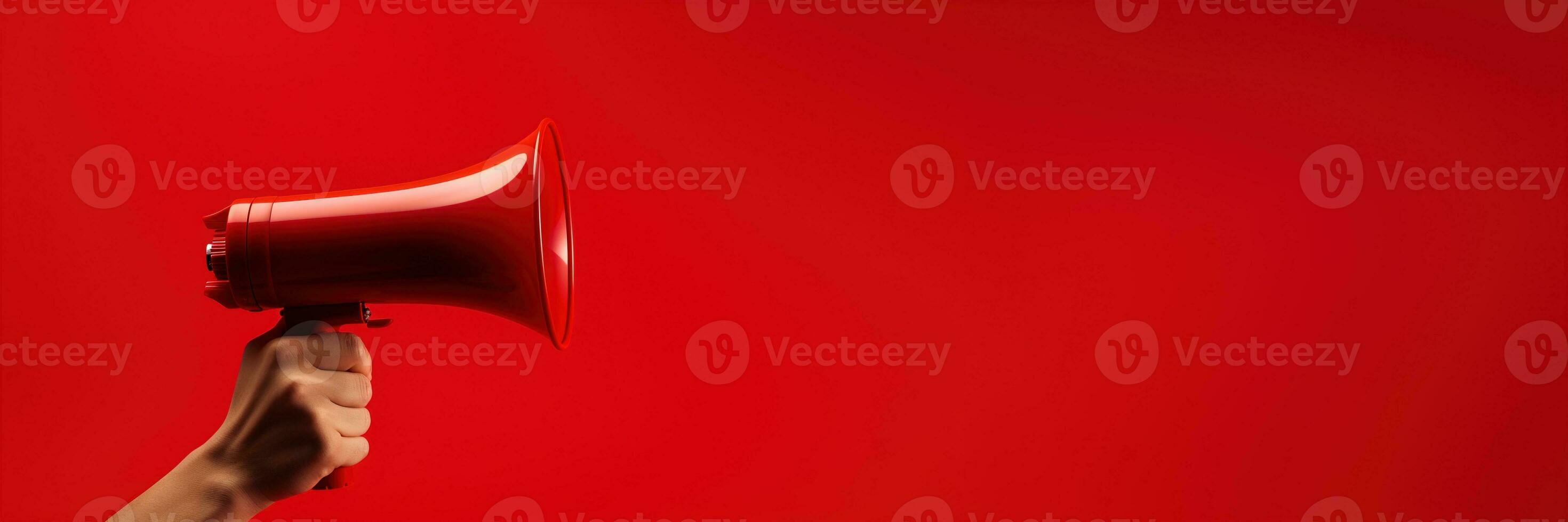 Generative AI, megaphone in hand on a empty red background, panoramic image with copy space photo