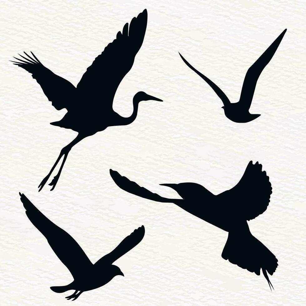 Flock of flying birds in a set of vector silhouettes