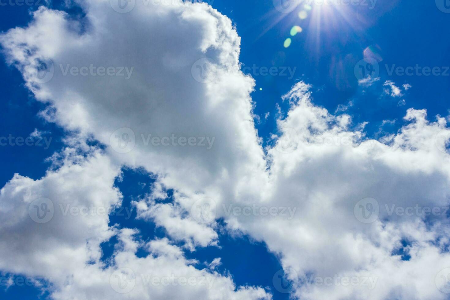 white fluffy clouds and sun photo