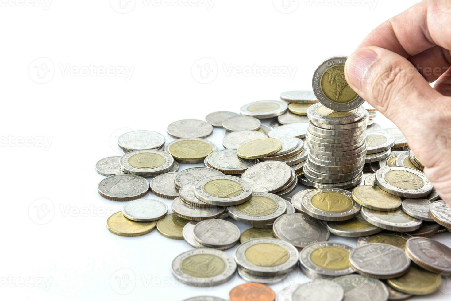 Hand put coins to stack of coins photo