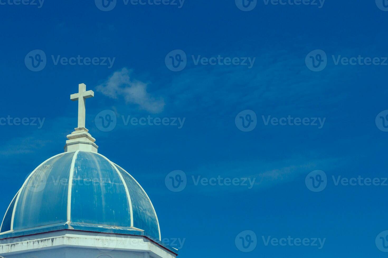 white cross on blue sky photo