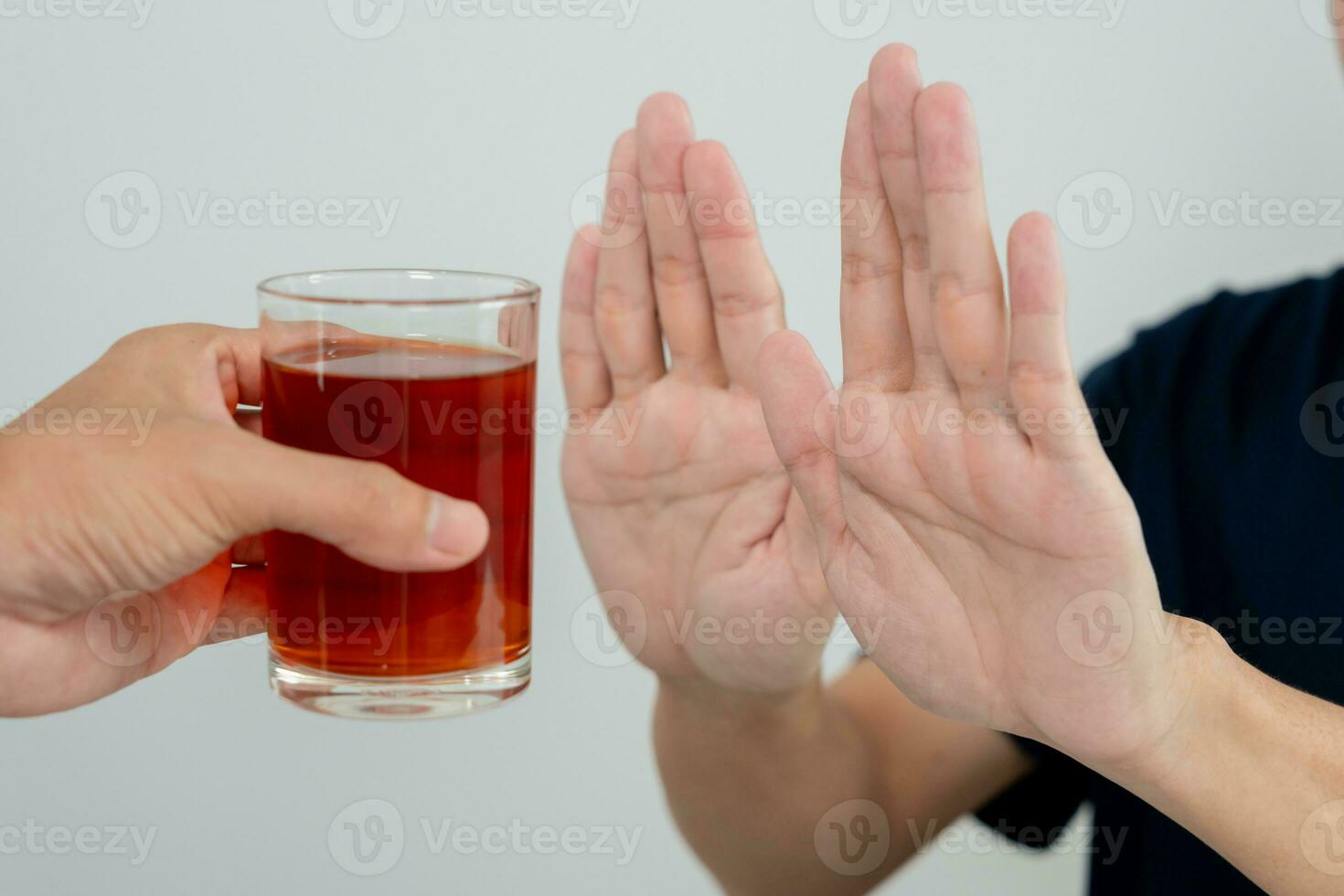 man refuses say no and avoid to drink an alcohol whiskey , stopping hand sign male, alcoholism treatment, alcohol addiction, quit booze, Stop Drinking Alcohol. Refuse Glass liquor, unhealthy, reject photo