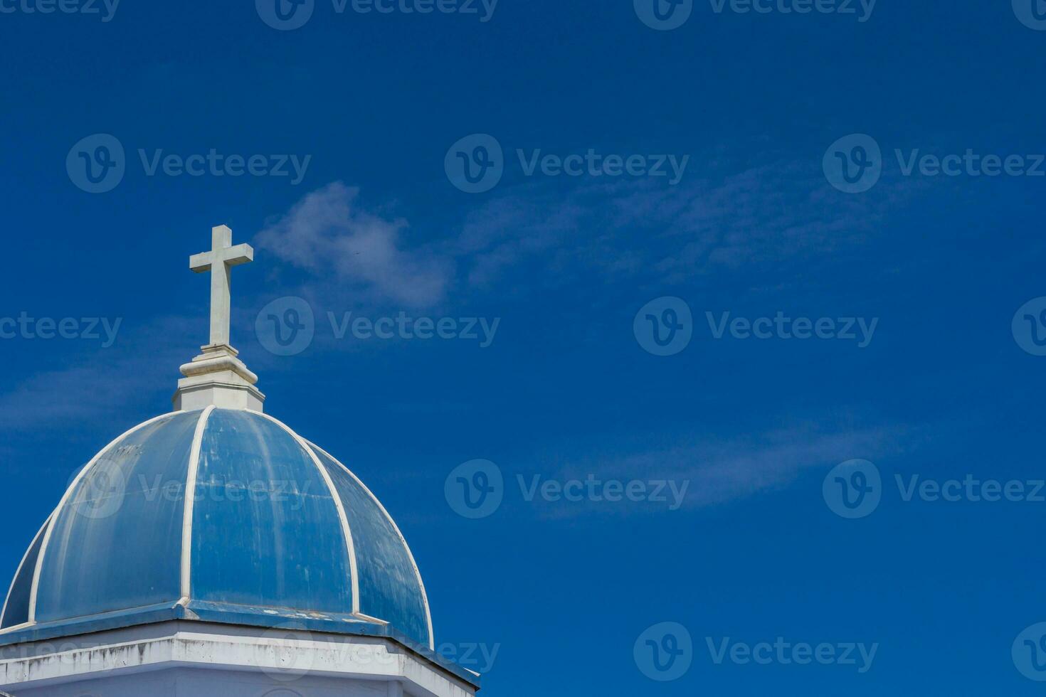 white cross on blue sky photo