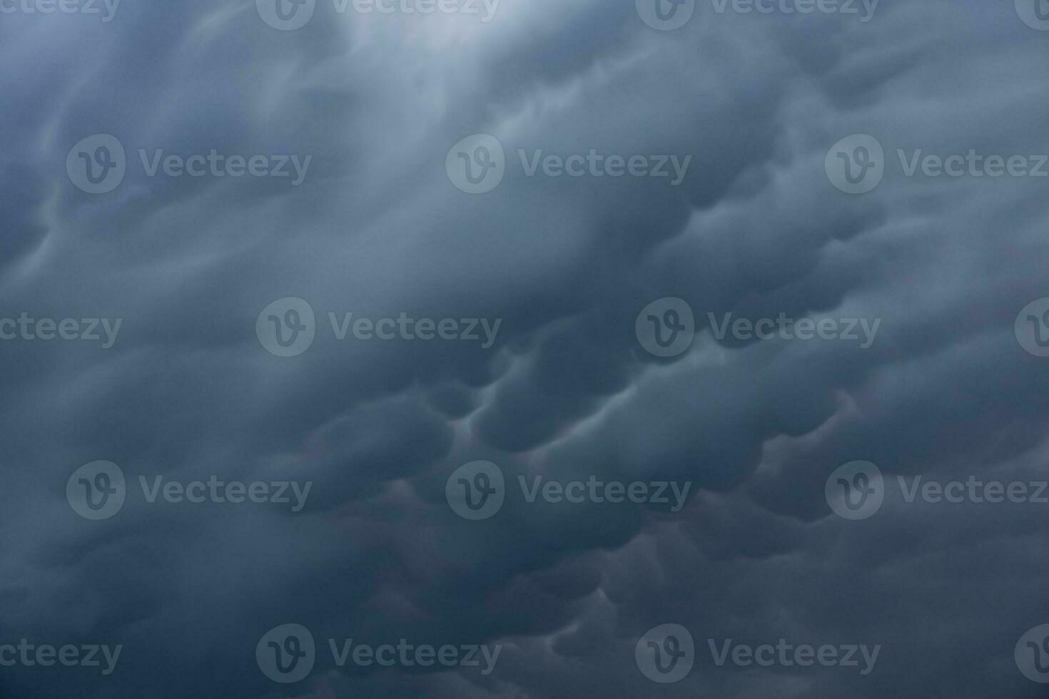 Large Mammatus clouds in the sky after a storm. a threatening heavy sky in clouds photo