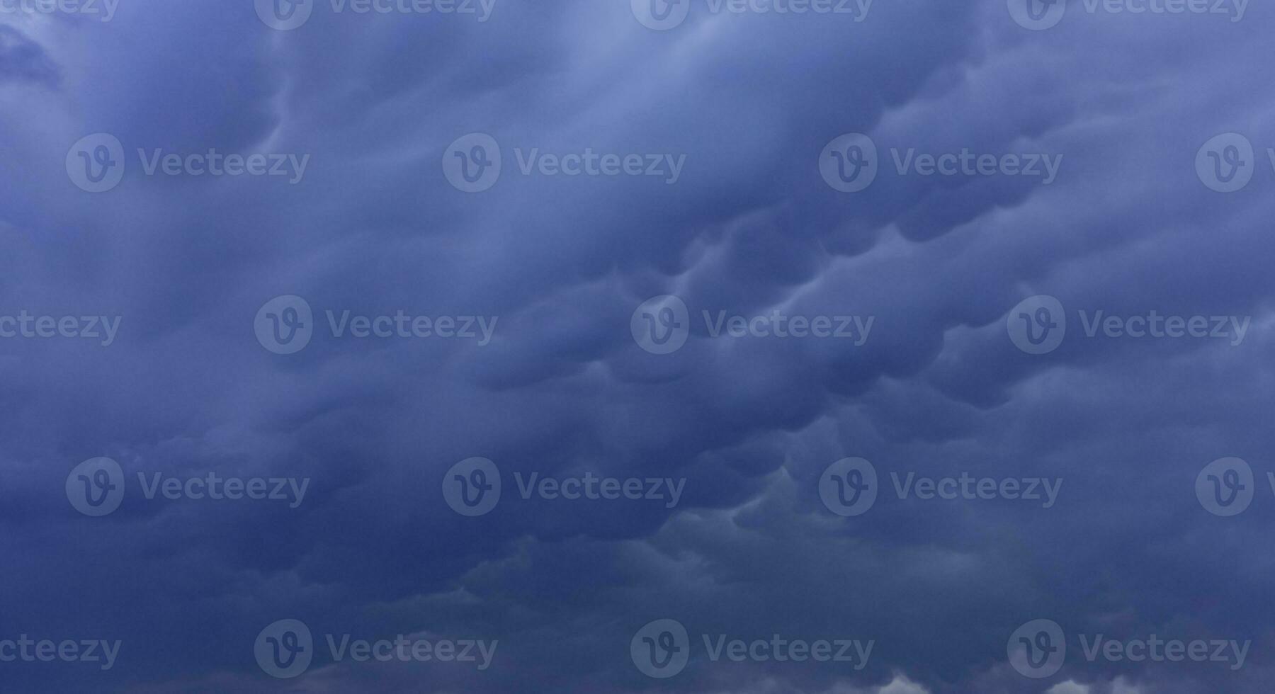 Large Mammatus clouds in the sky after a storm. a threatening heavy sky in clouds photo