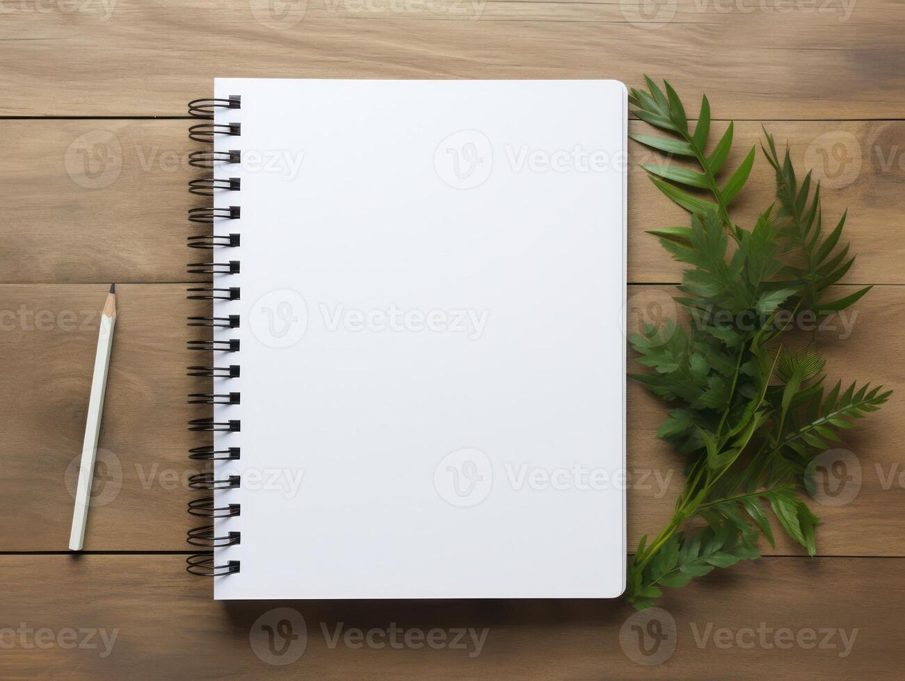 Top view of spiral notebok with pencil on wooden table. Emtry page for text. . photo