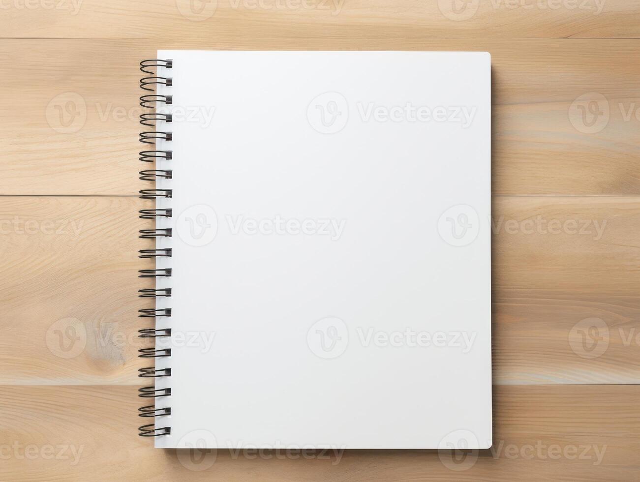 Top view of spiral notebok with pencil on wooden table. Emtry page for text. . photo