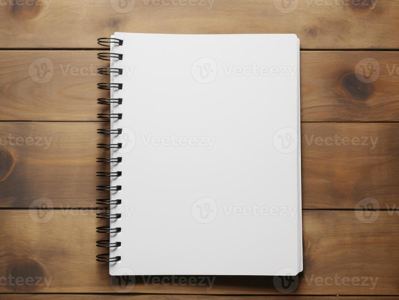 Top view of spiral notebok with pencil on wooden table. Emtry page for text. . photo