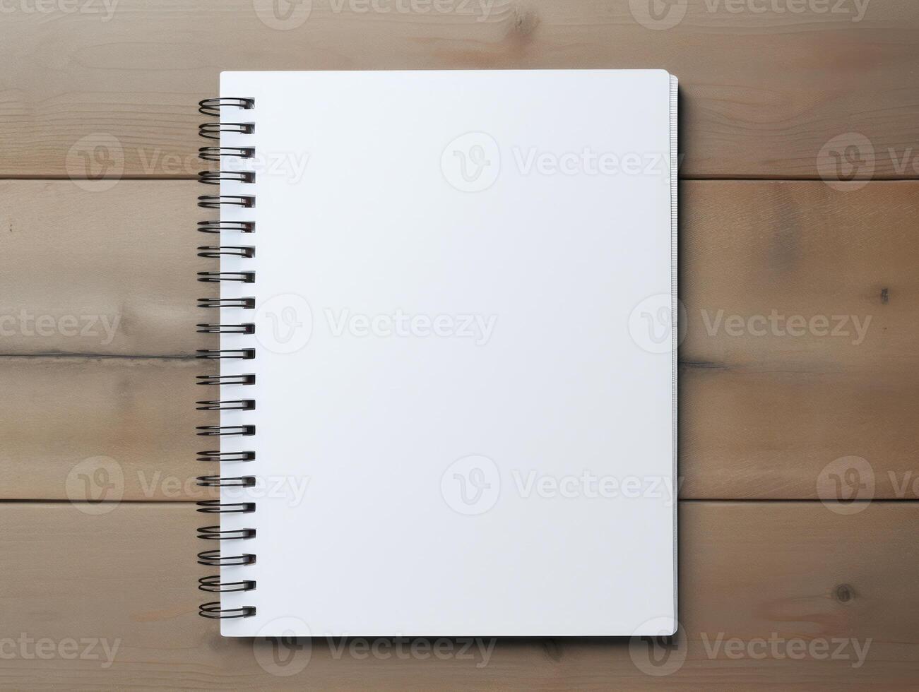 Top view of spiral notebok with pencil on wooden table. Emtry page for text. . photo