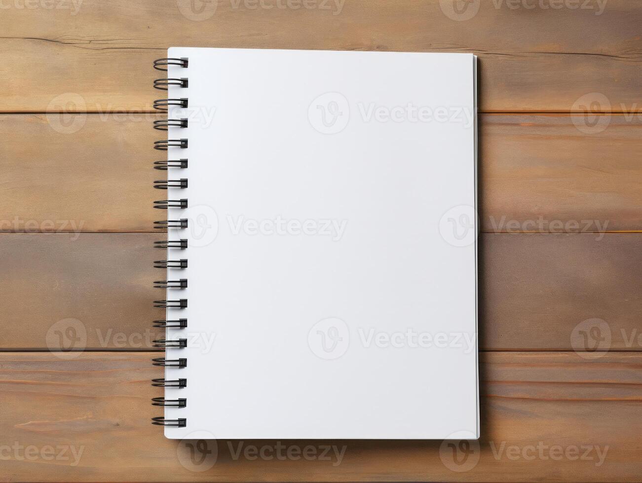 Top view of spiral notebok with pencil on wooden table. Emtry page for text. . photo