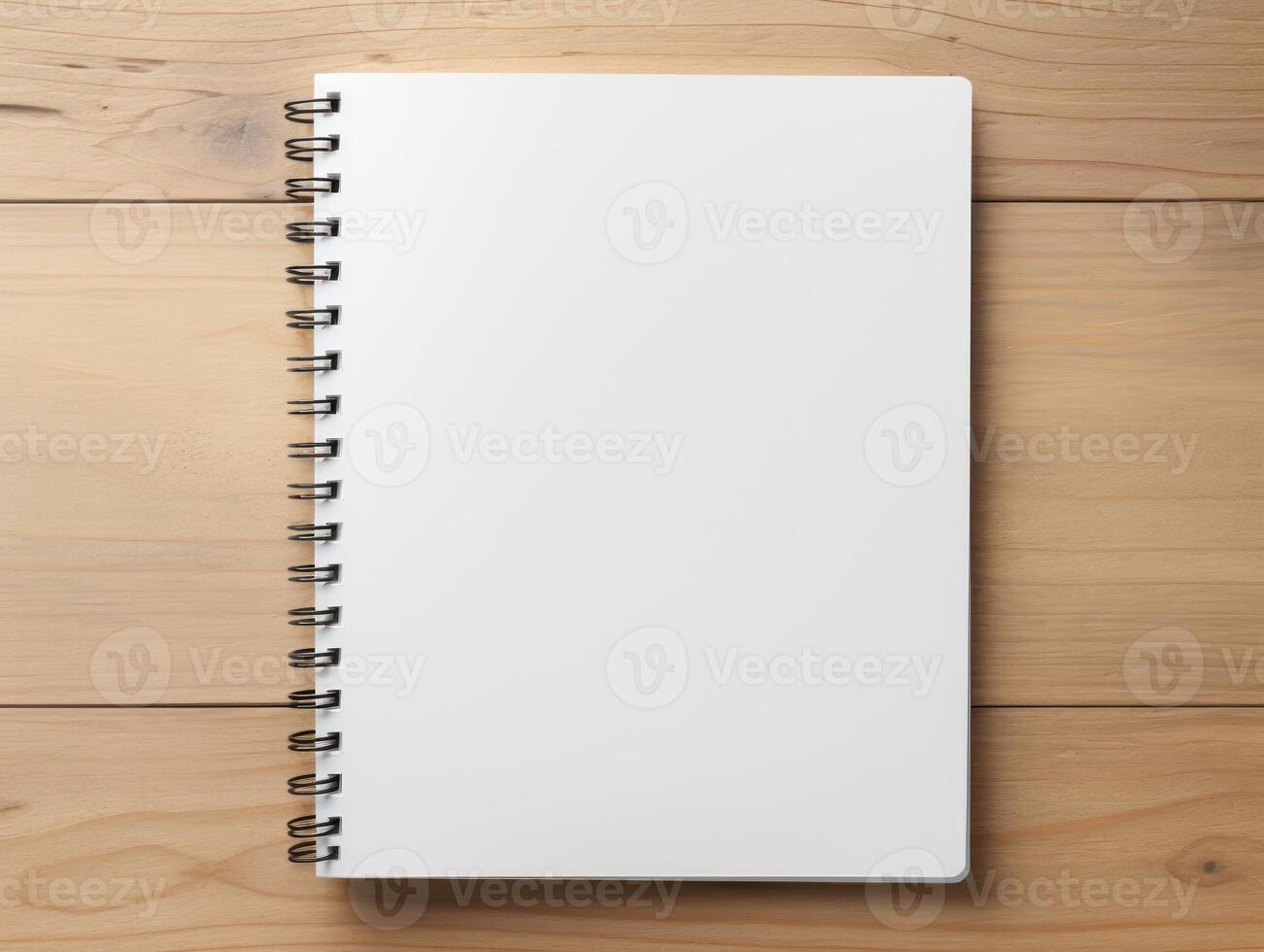 Top view of spiral notebok with pencil on wooden table. Emtry page for text. . photo