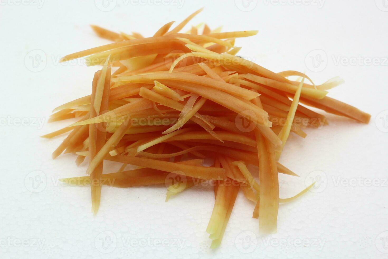 Fresh shredded papaya for salad on white background photo