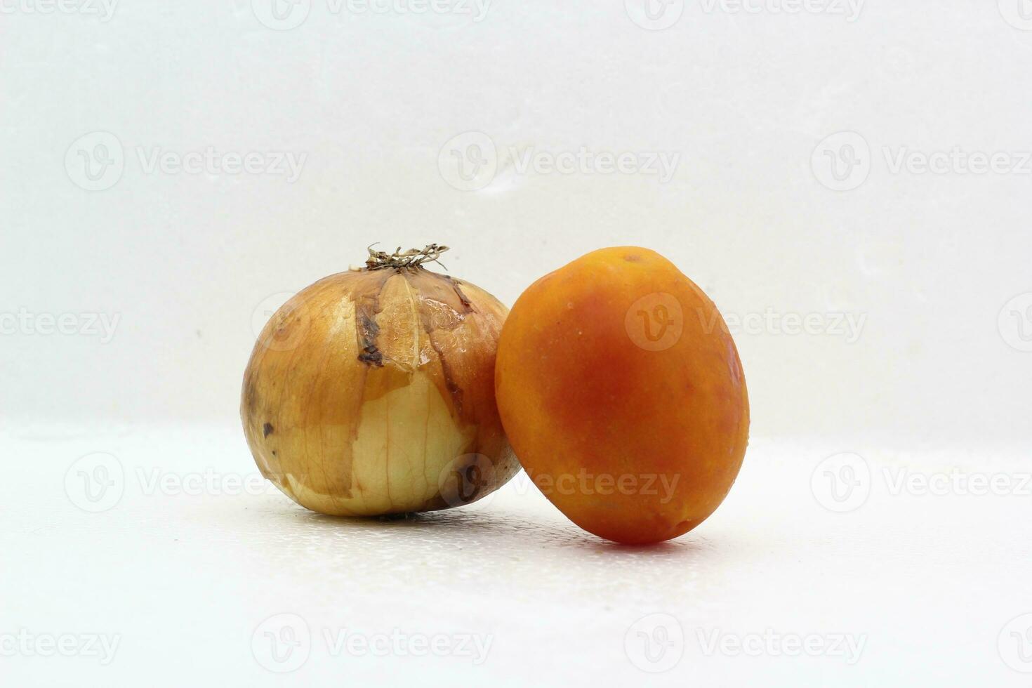 Red tomatoes in a pair with onions on a white background photo