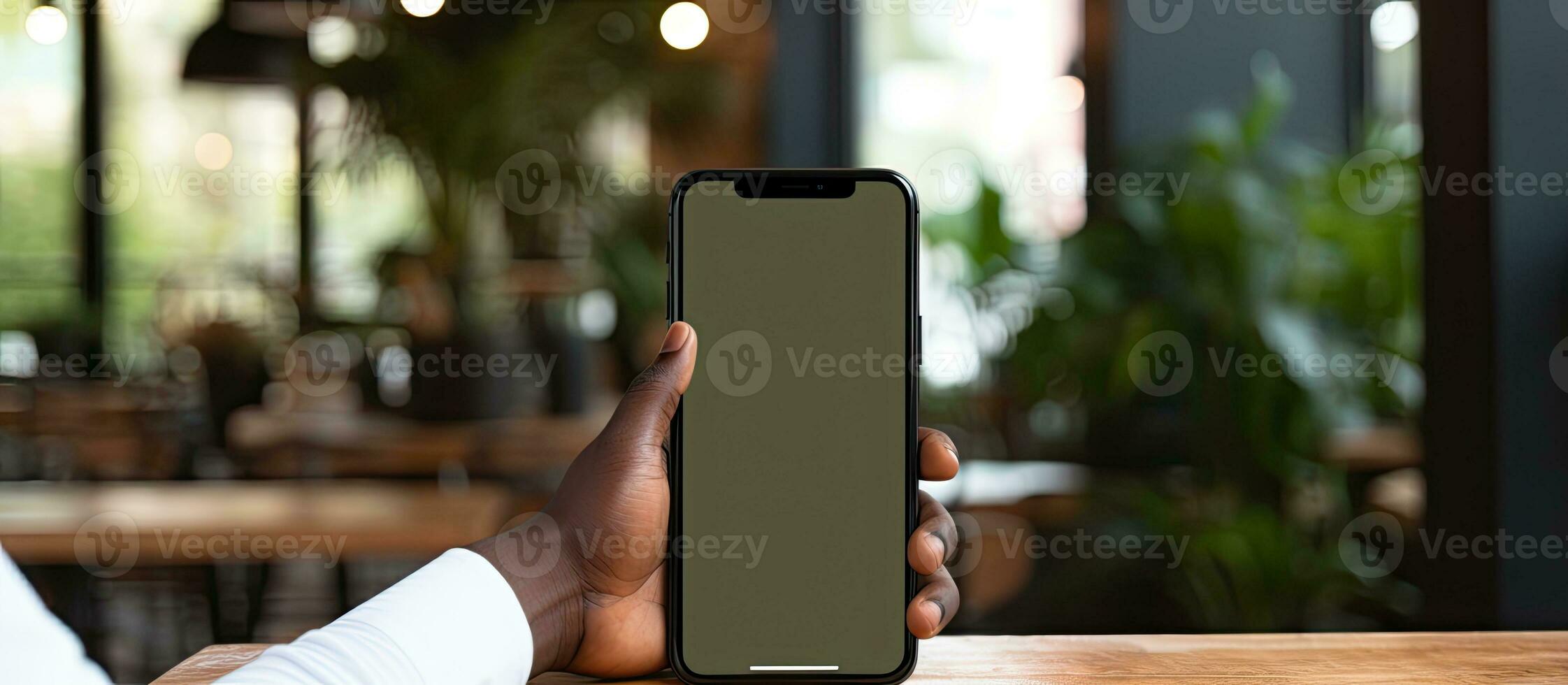 African American man working with code on smartphone at office desk IT developer concept photo