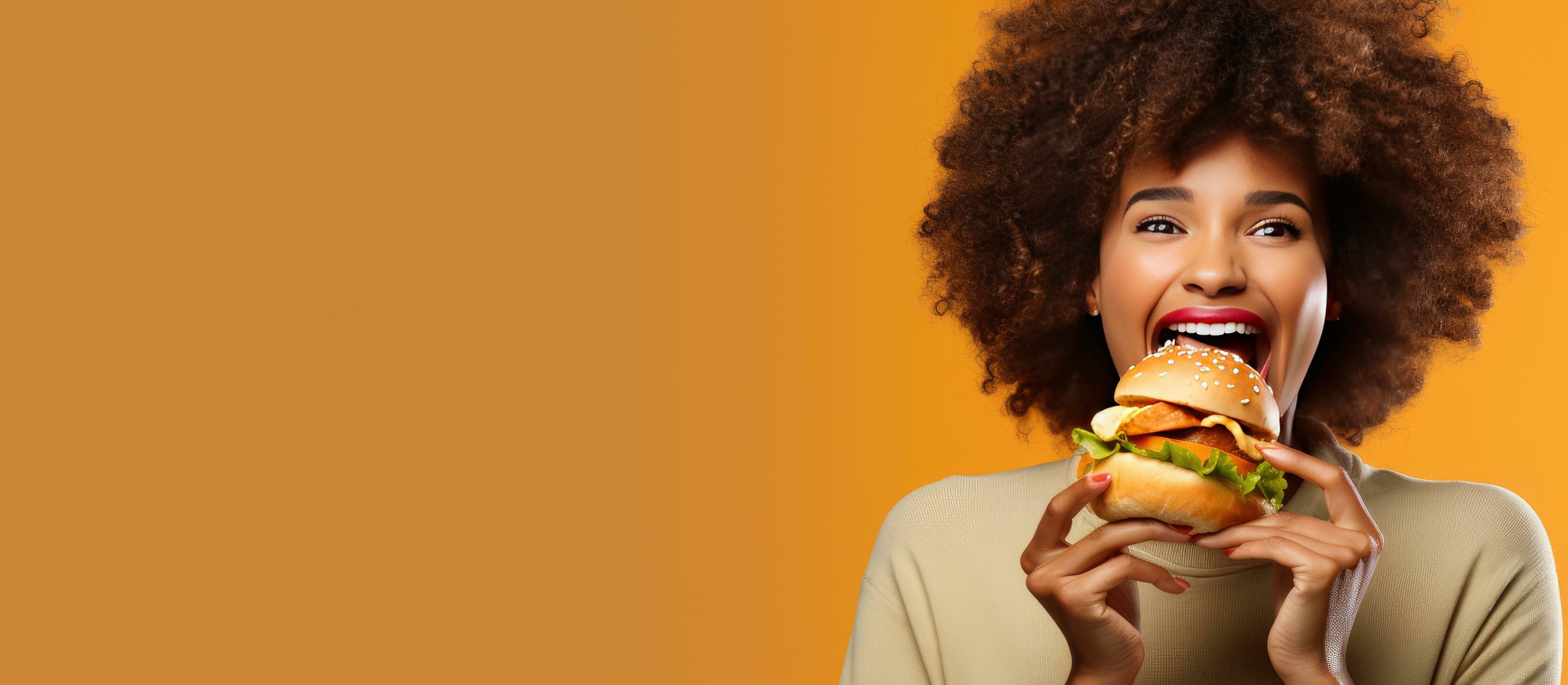 Indulging in fast food meal Happy African American woman enjoying