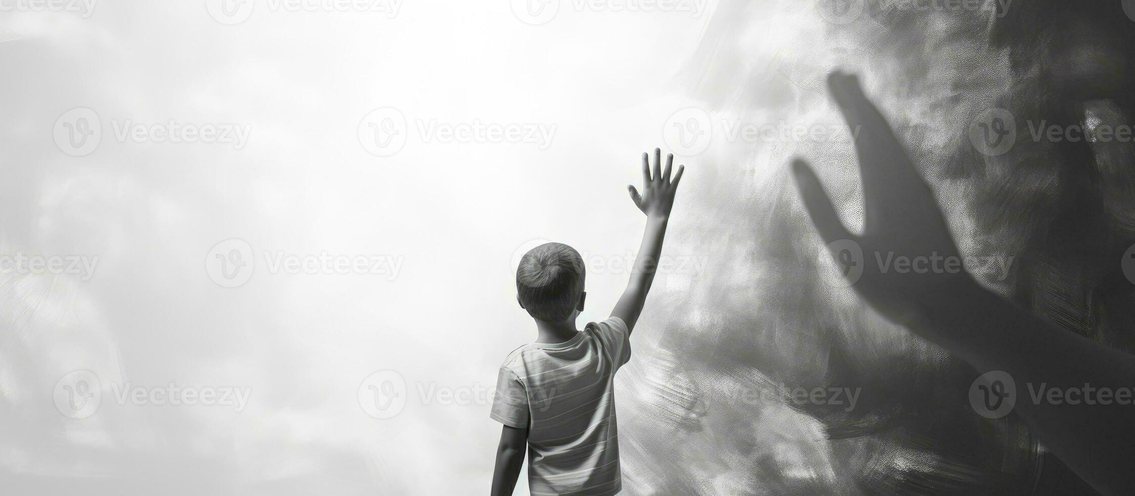 Child high five adult in front of black and white wall photo
