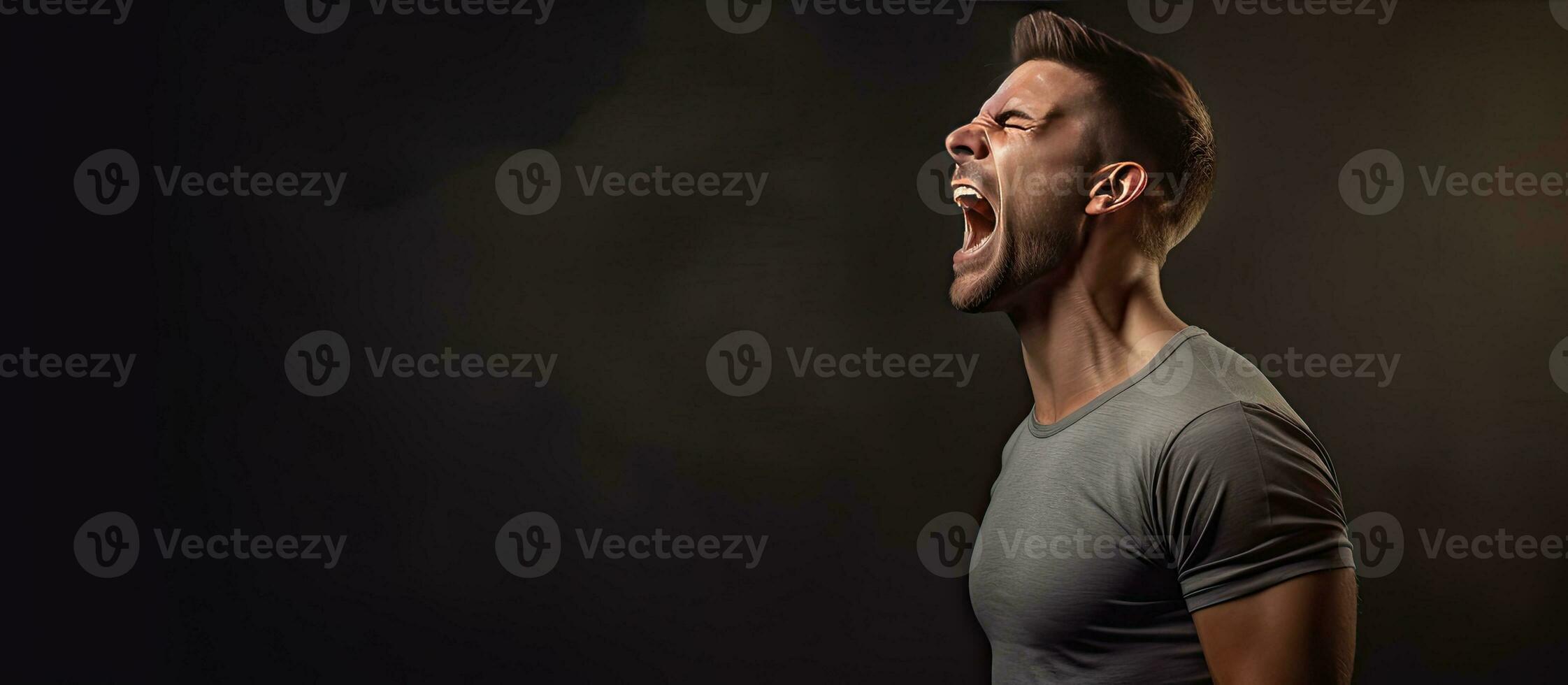 A furious young man gesturing and yelling loudly in a blank area photo