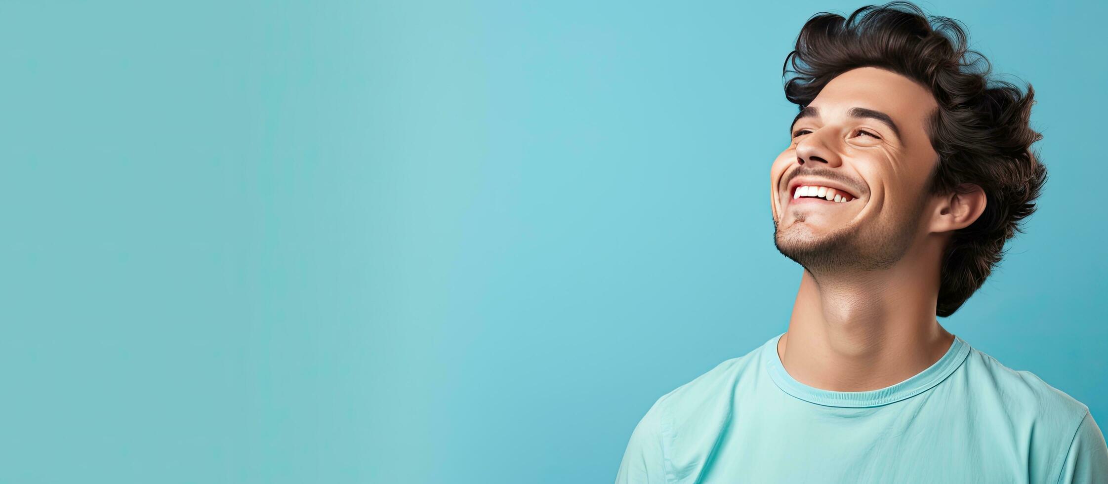 A content attractive young man happily holding an object in a blank area photo
