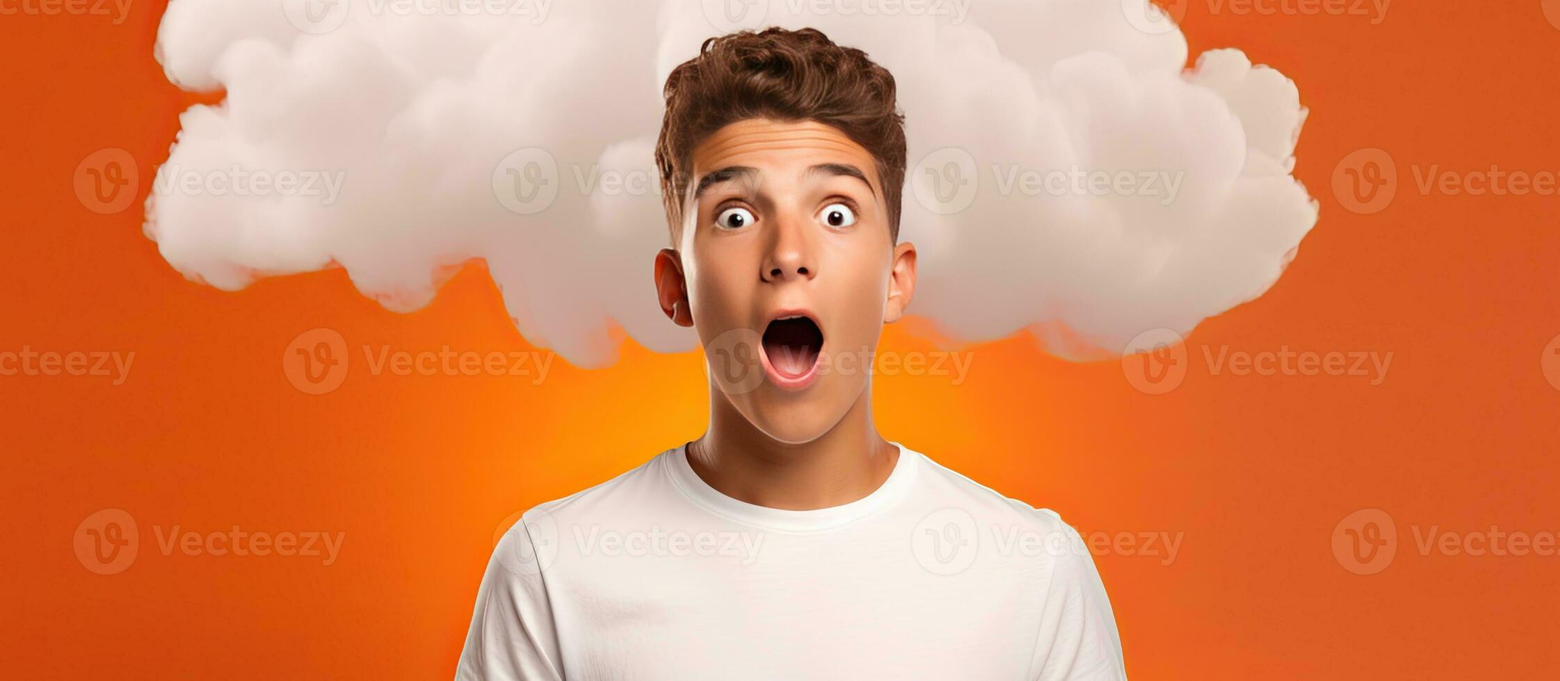 Surprised Caucasian teenage boy showcasing cloud design for advertisement and promotion isolated on orange backdrop Suggested for learning and school photo