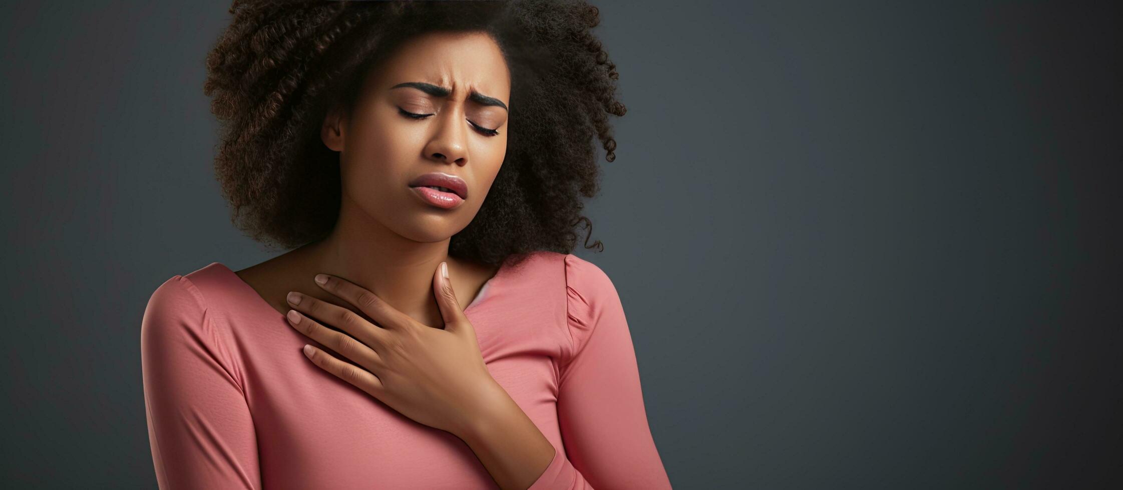 Unhappy young black woman with acid reflux isolated on gray background photo