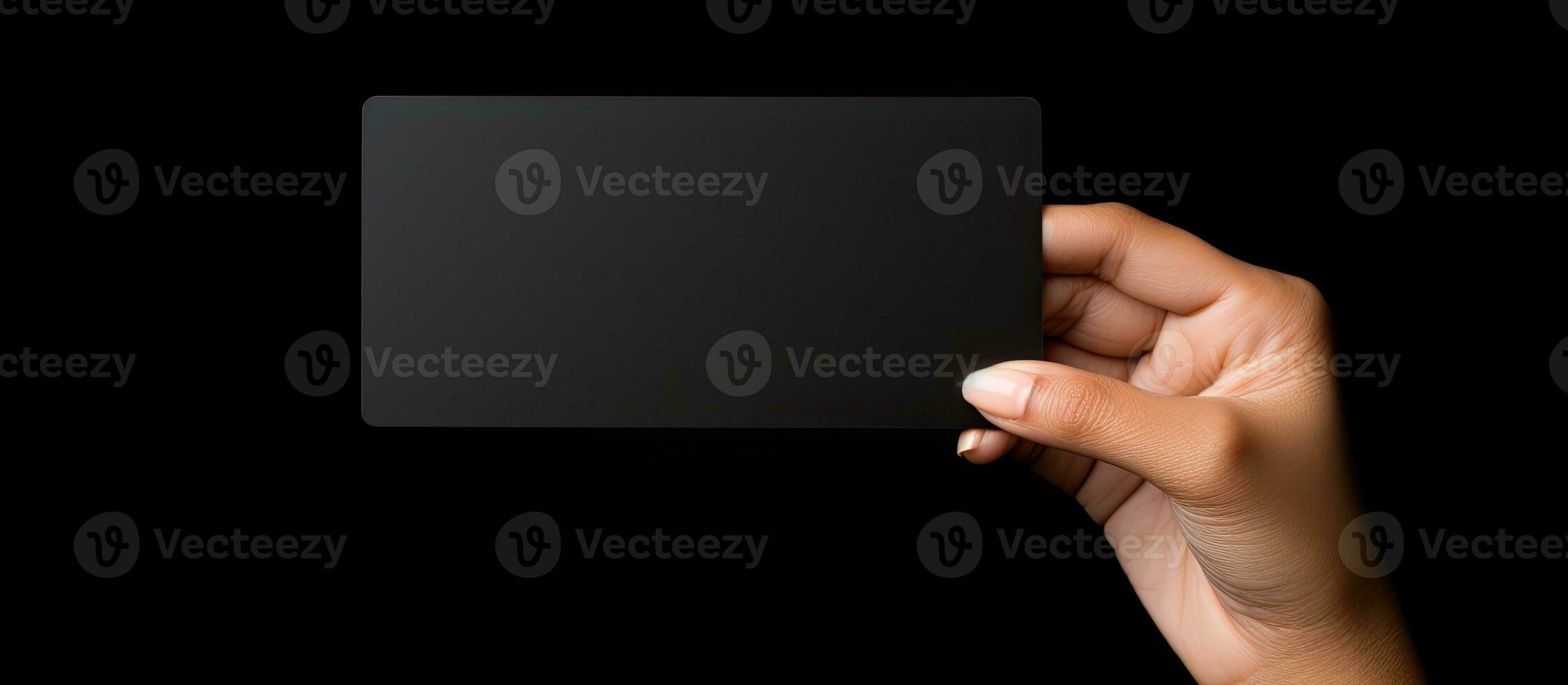 Caucasian woman s hand holds black business card on black background Symbolizes business and writing space photo