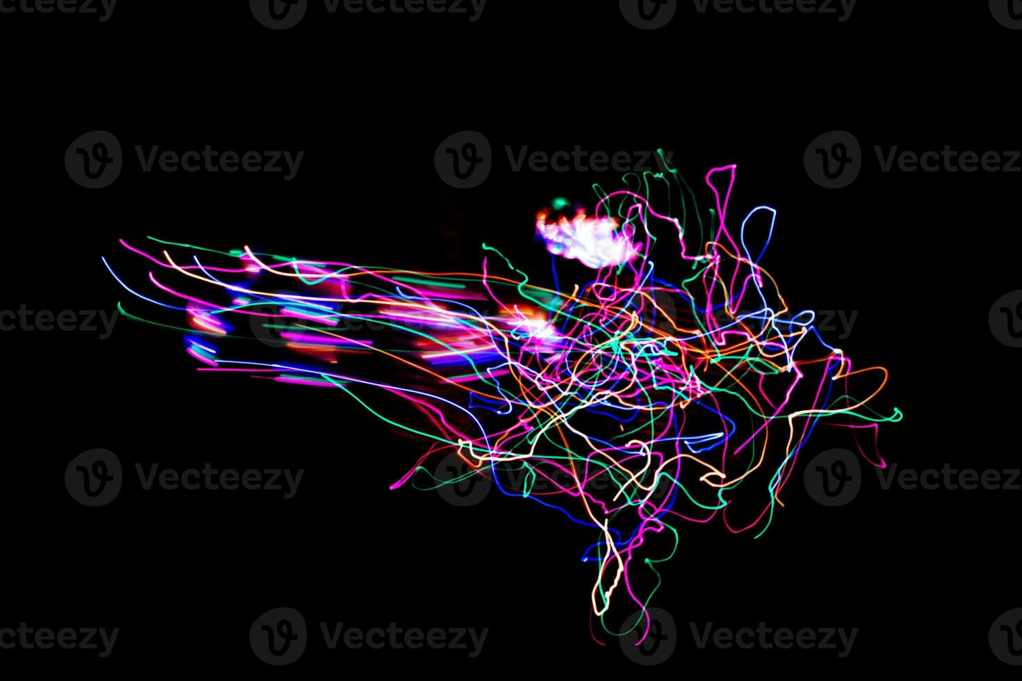 Multi color light painting photography, swirl and curve of blue, green and red light against a black background. photo