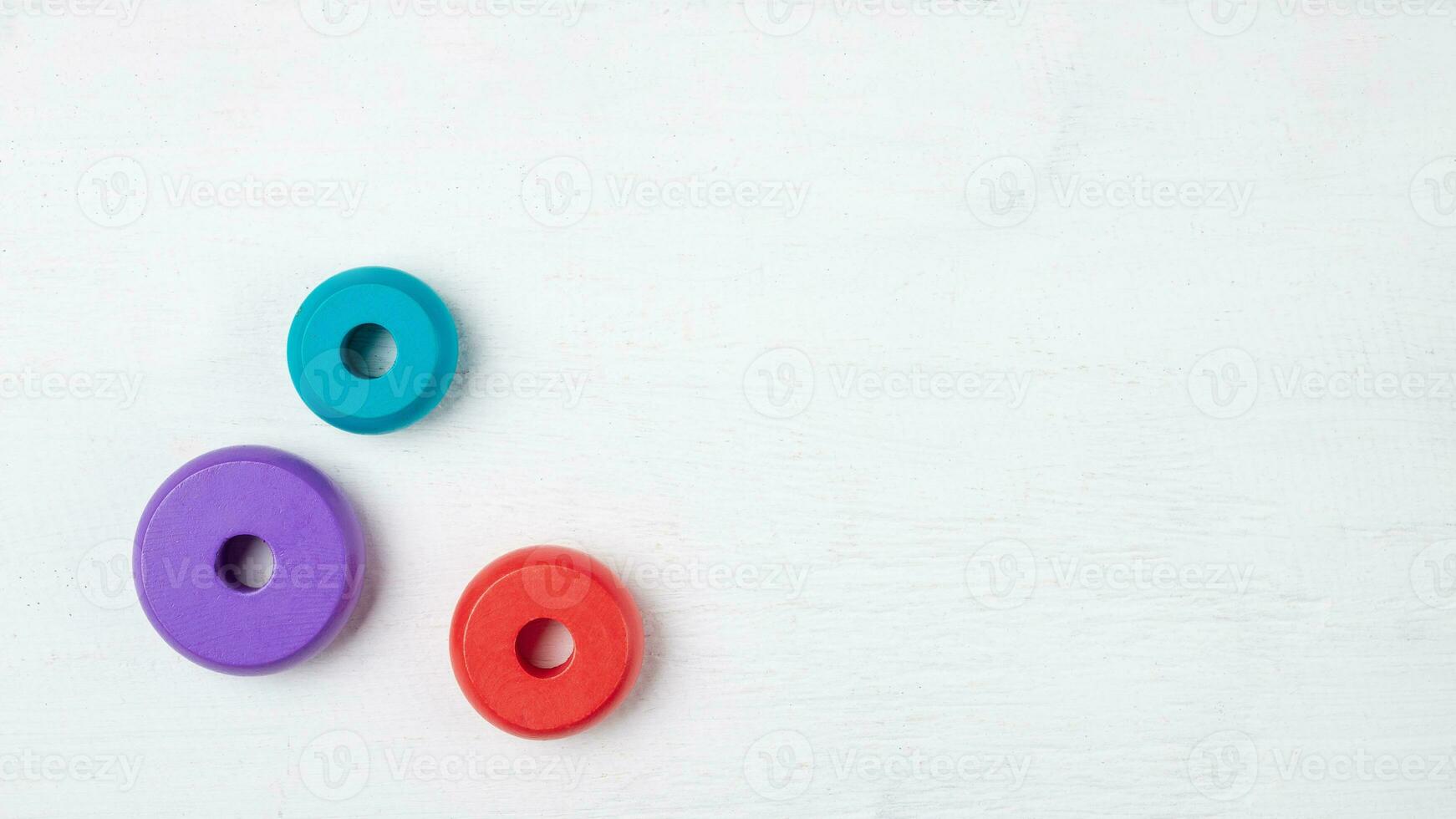 Colorful kids toys on white wooden background. Top view. Flat lay. Copy space for text photo