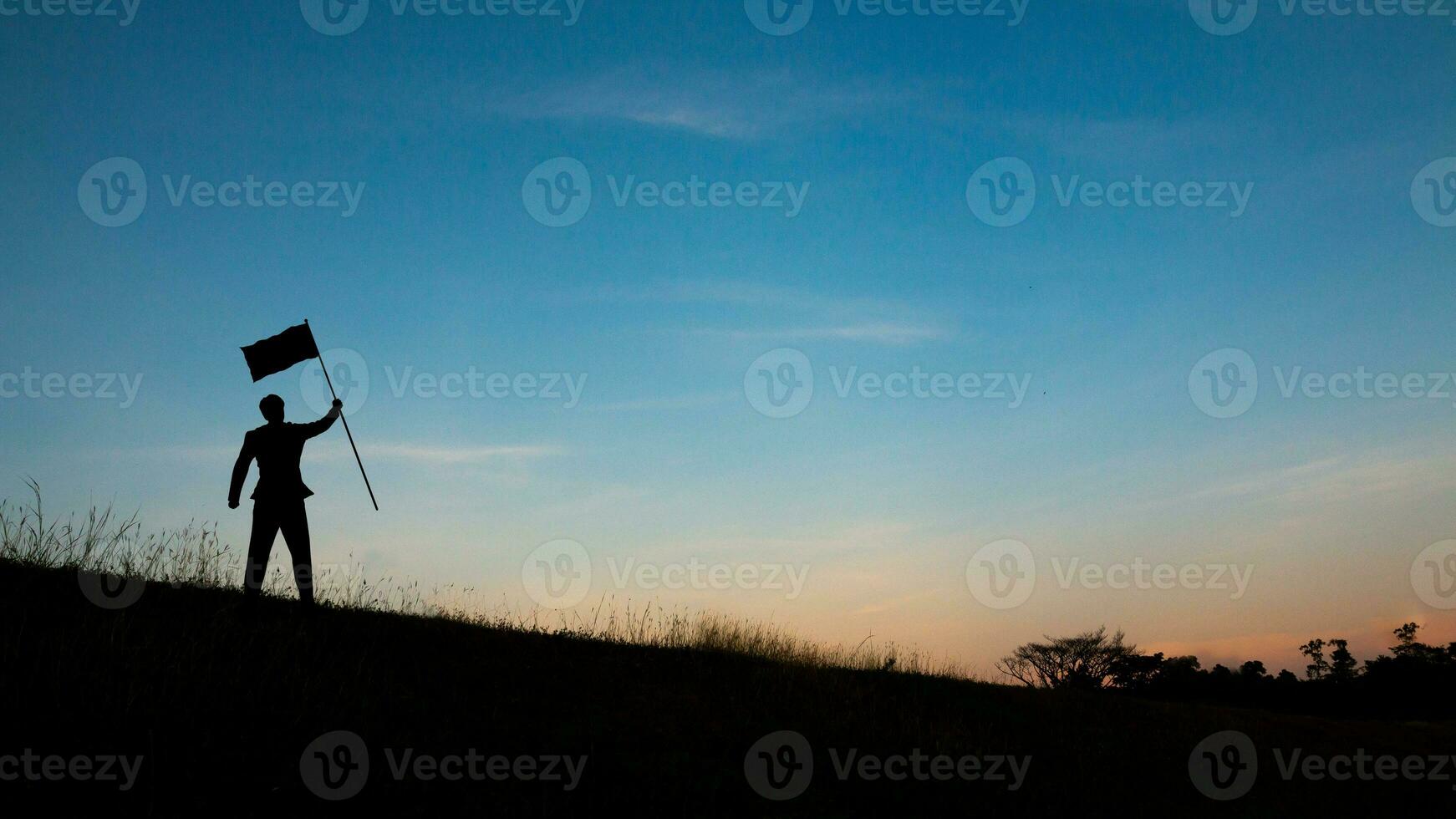 Motivation for trying to succeed in business, Silhouette of man on mountain top over sky and sun light background,business, success, leadership, achievement and people concept photo