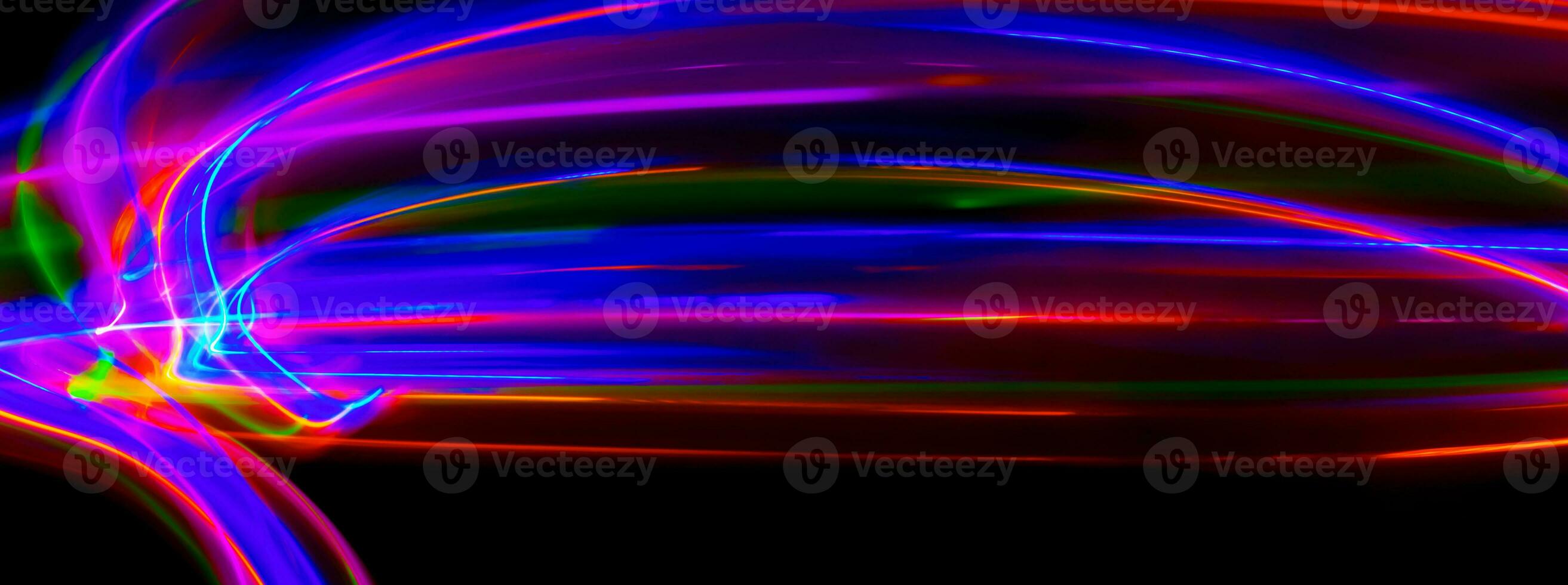 Multi color light painting photography, swirl and curve of blue, green and red light against a black background. photo