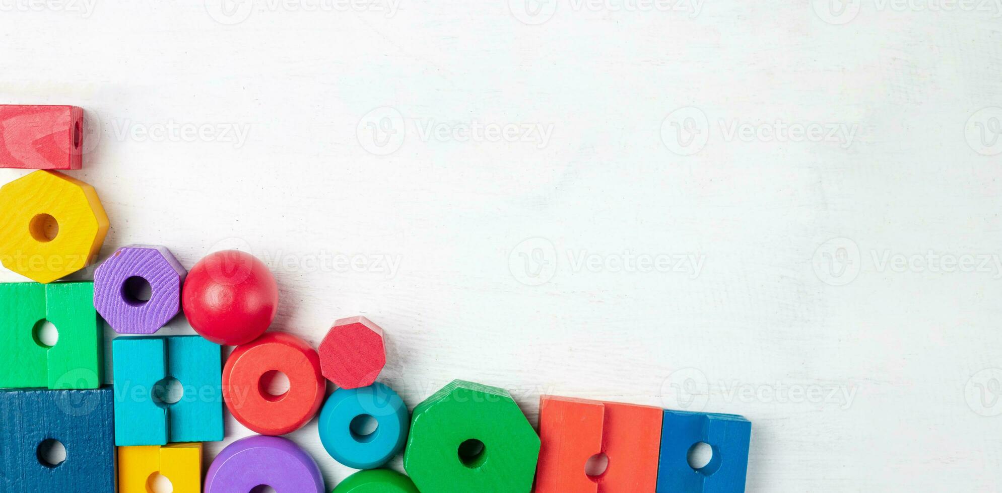Colorful kids toys on white wooden background. Top view. Flat lay. Copy space for text photo