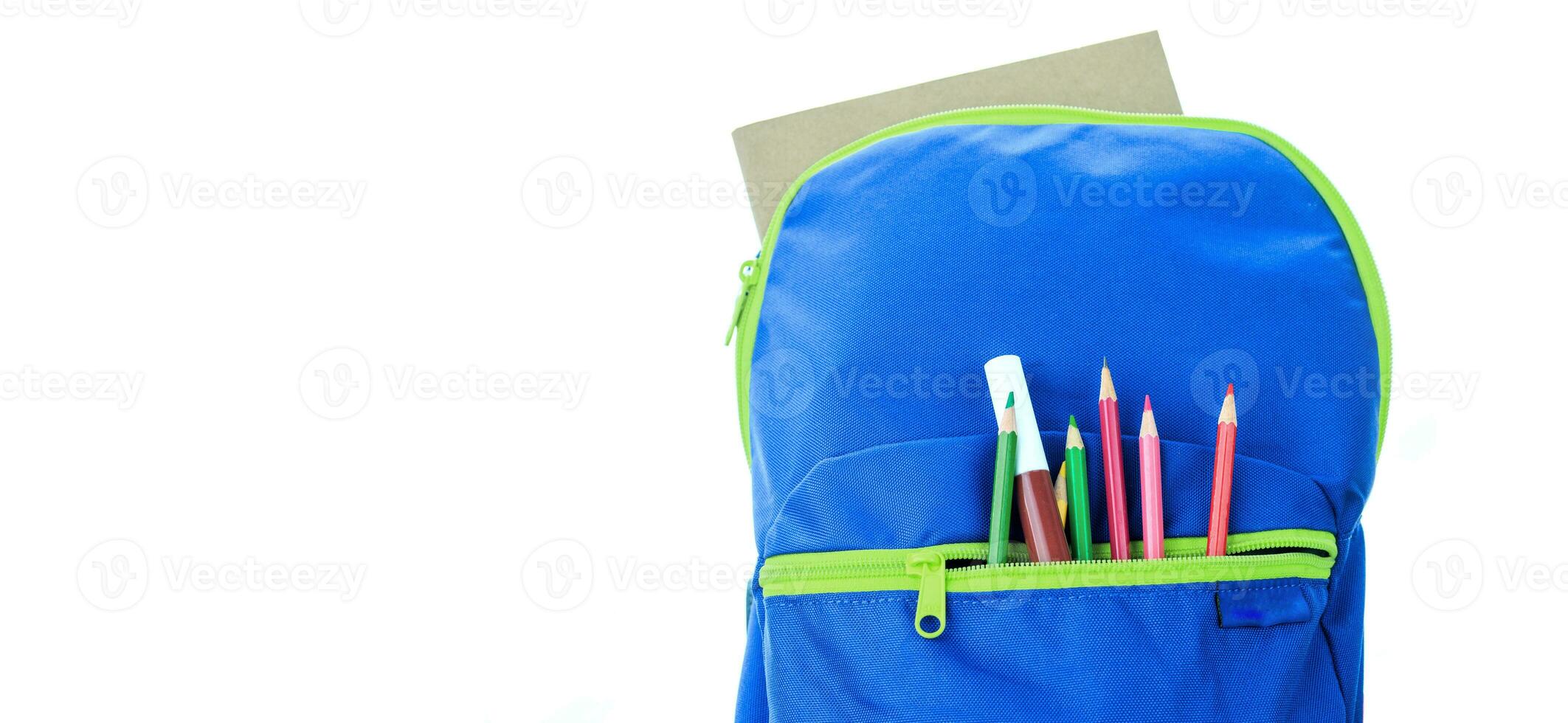 School supplies for school children In a blue backpack on a white background. photo