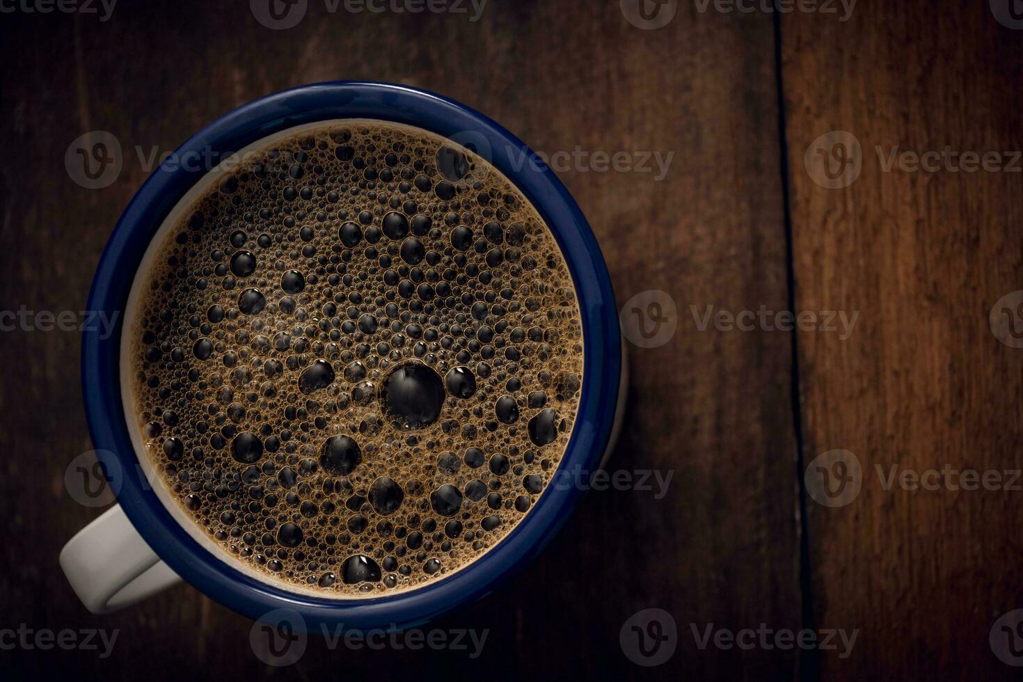 Cup of coffee on wooden background. Copy space. Top view. Flat lay photo